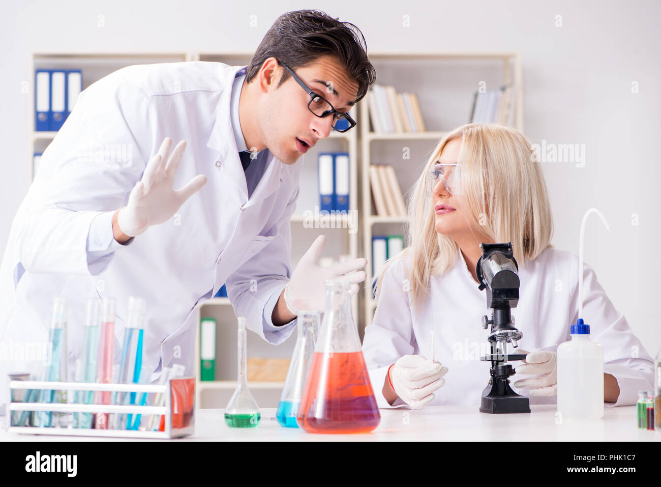 Two biologist examining liquid hi-res stock photography and images - Alamy