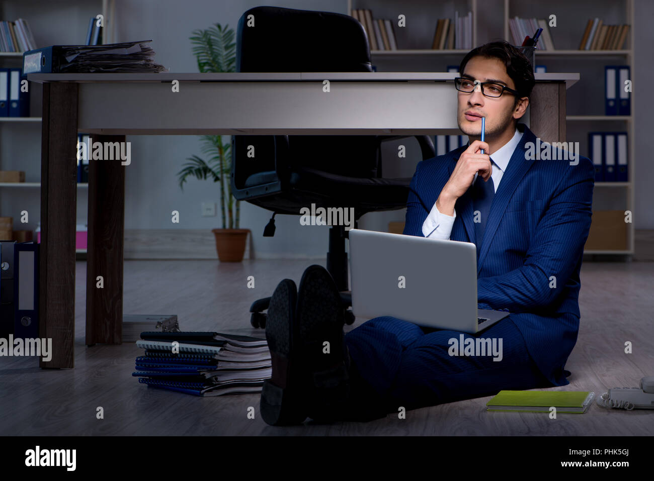 Working long hours in office hi-res stock photography and images - Alamy