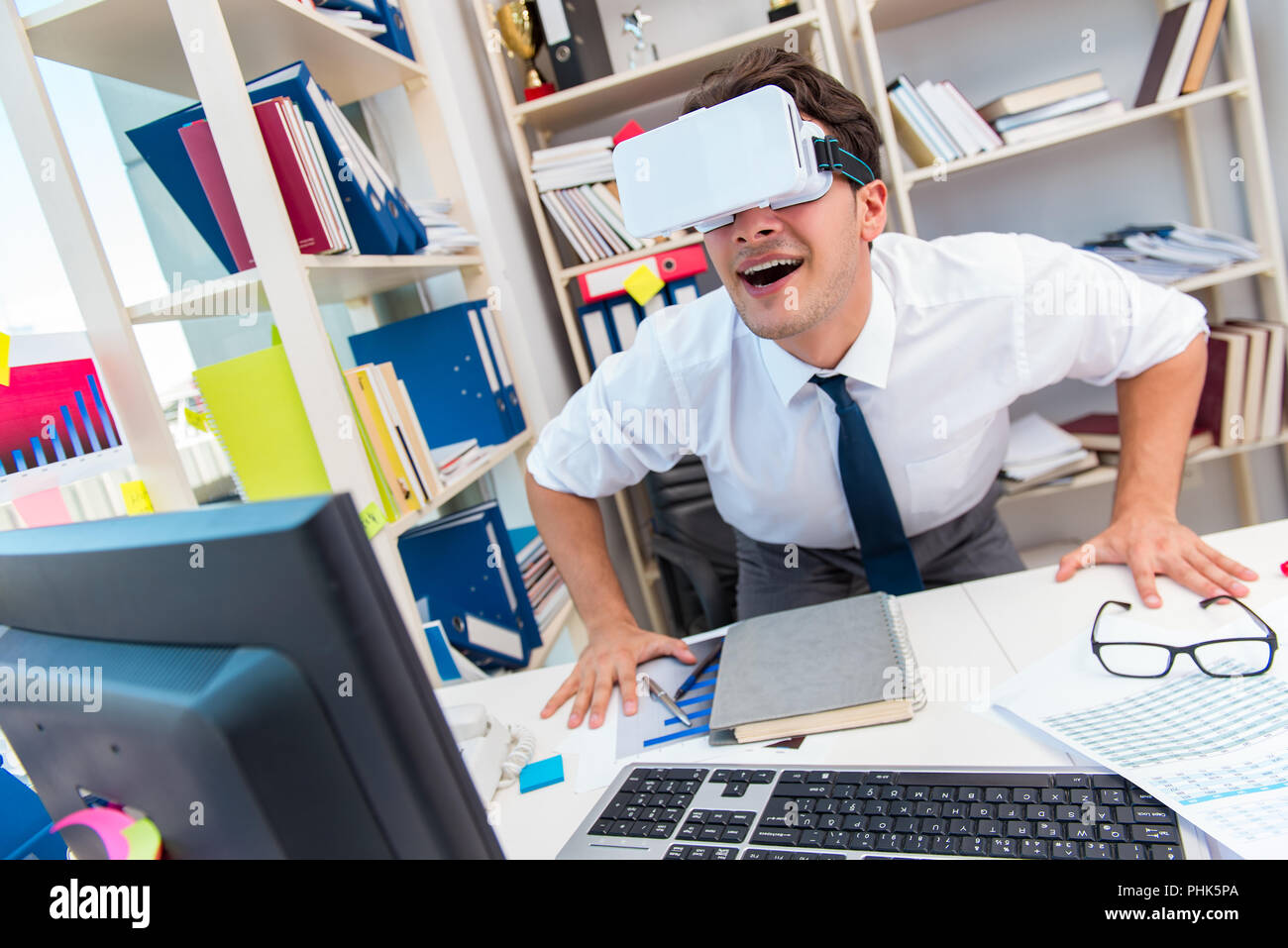 Employee watching movie on vr virtual reality glasses Stock Photo - Alamy