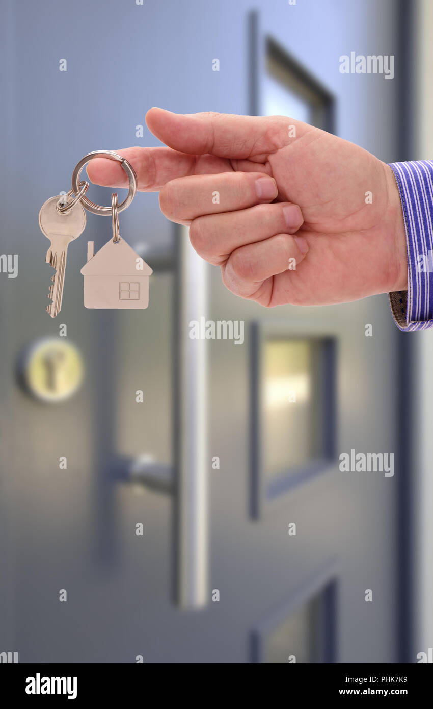 key for new home in hand of real estate agent Stock Photo