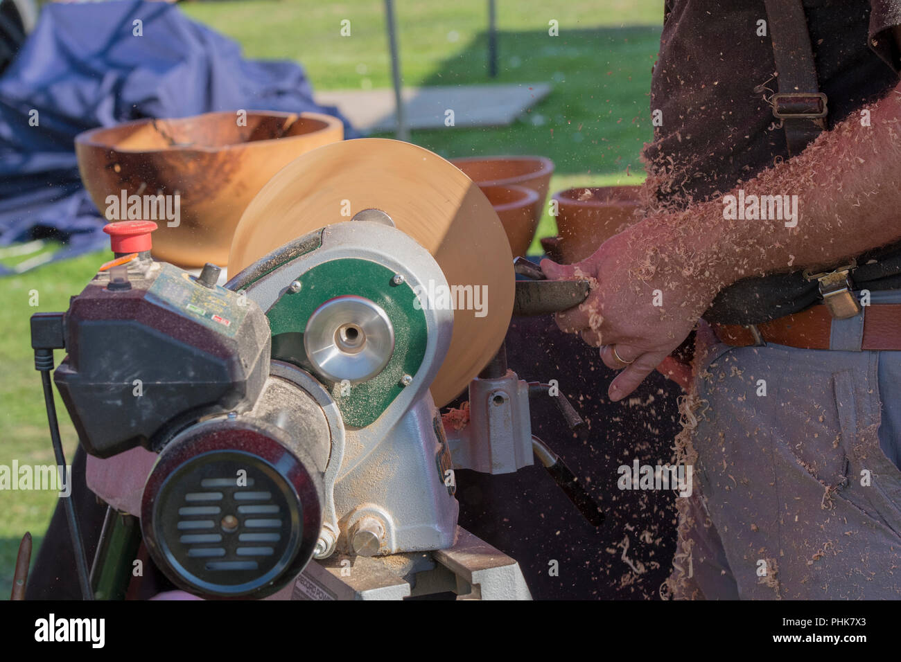 a wood turner using a lathe and a chisel. woodworking on a lathe