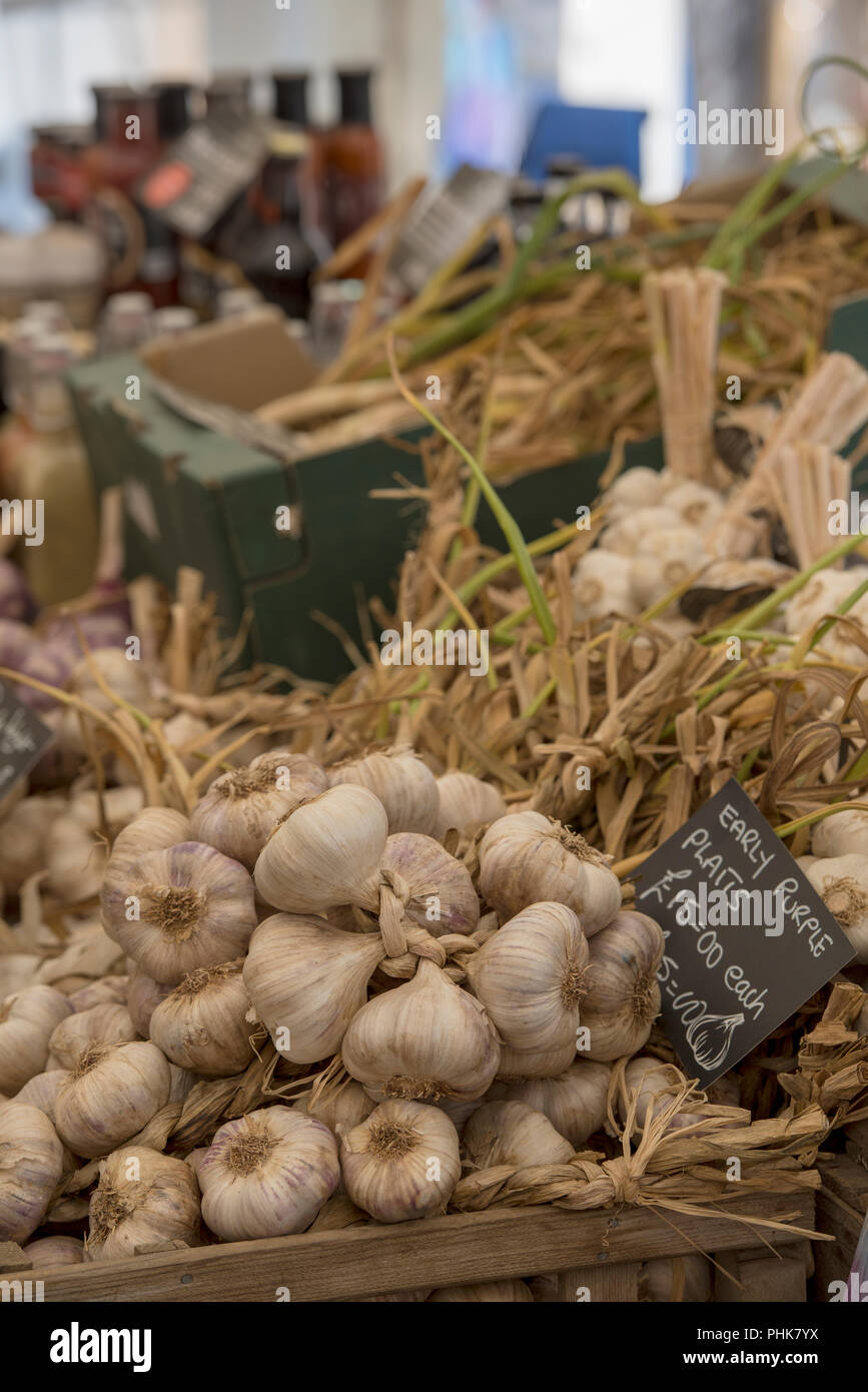 a variety of fresh garlic plaits and garlic related products on sale at the garlic farm, isle of wight, uk. Stock Photo