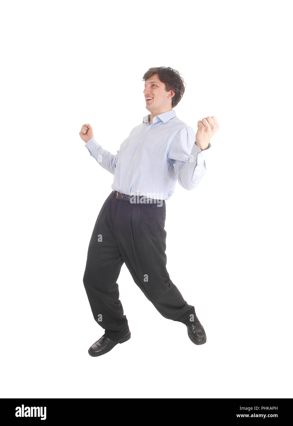 Happy young man dancing in shirt and dress pants Stock Photo