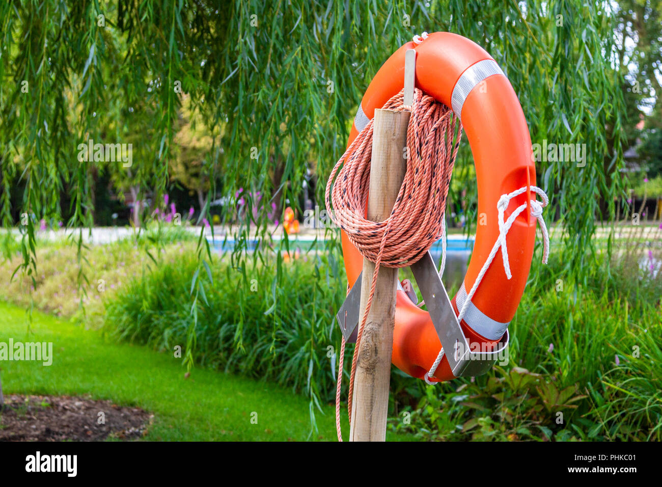 A rescue lifebelt in front of the lake Stock Photo