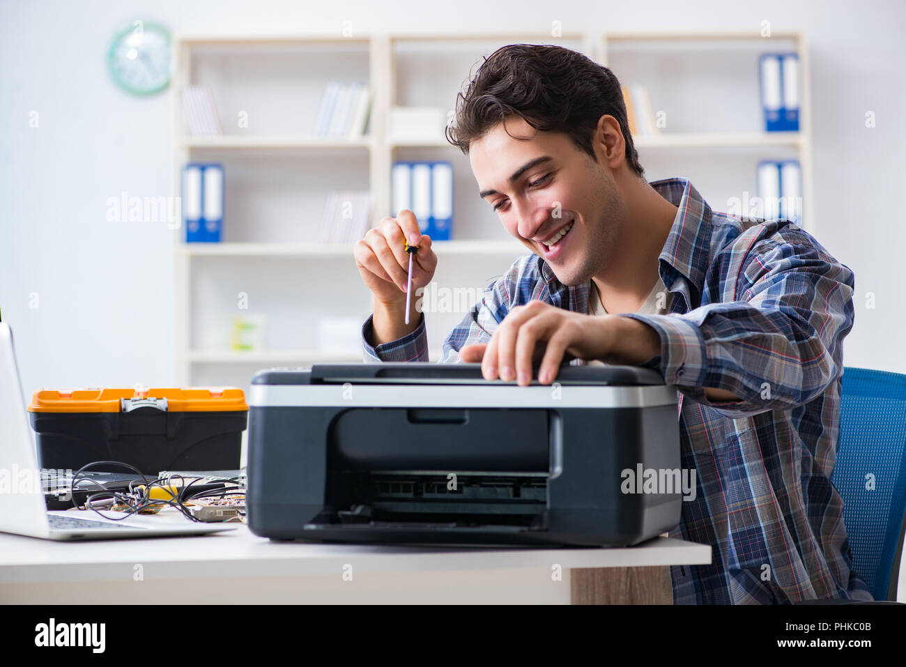Hardware repairman repairing broken printer fax machine Stock Photo Alamy