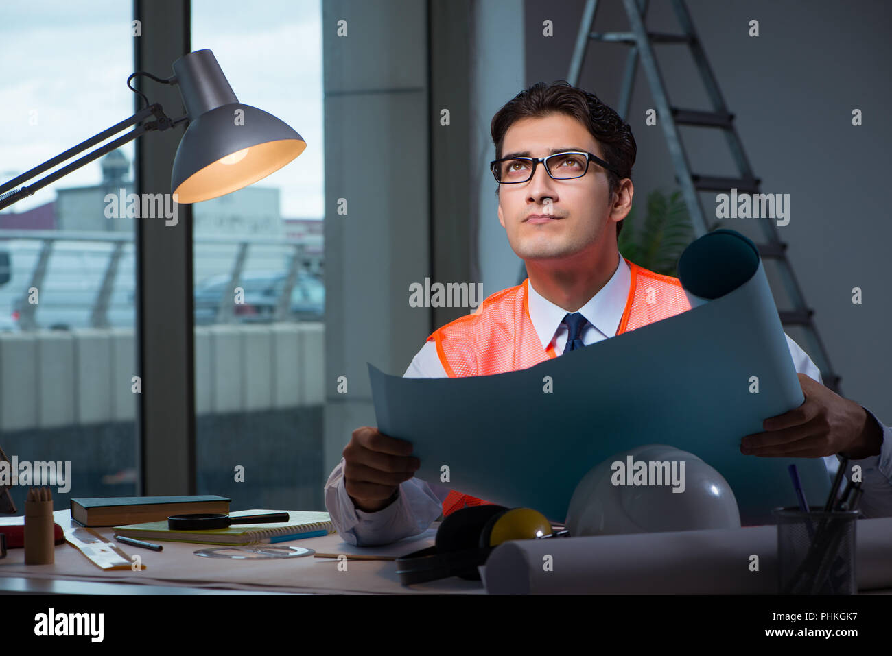 Construction architect working on drawings late at night Stock Photo ...