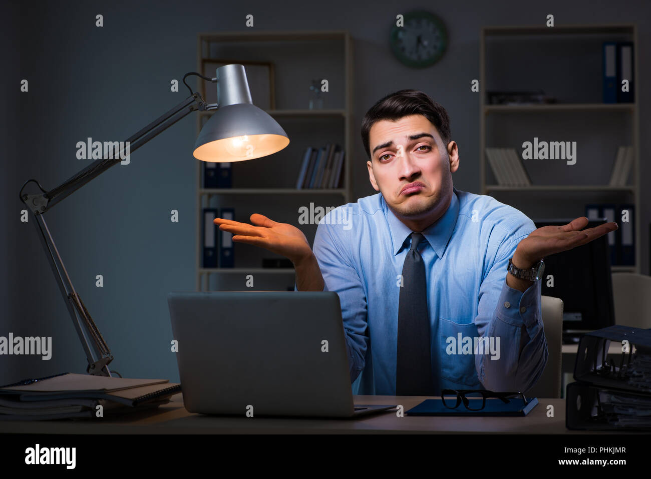 Employee working late at night at important report Stock Photo - Alamy