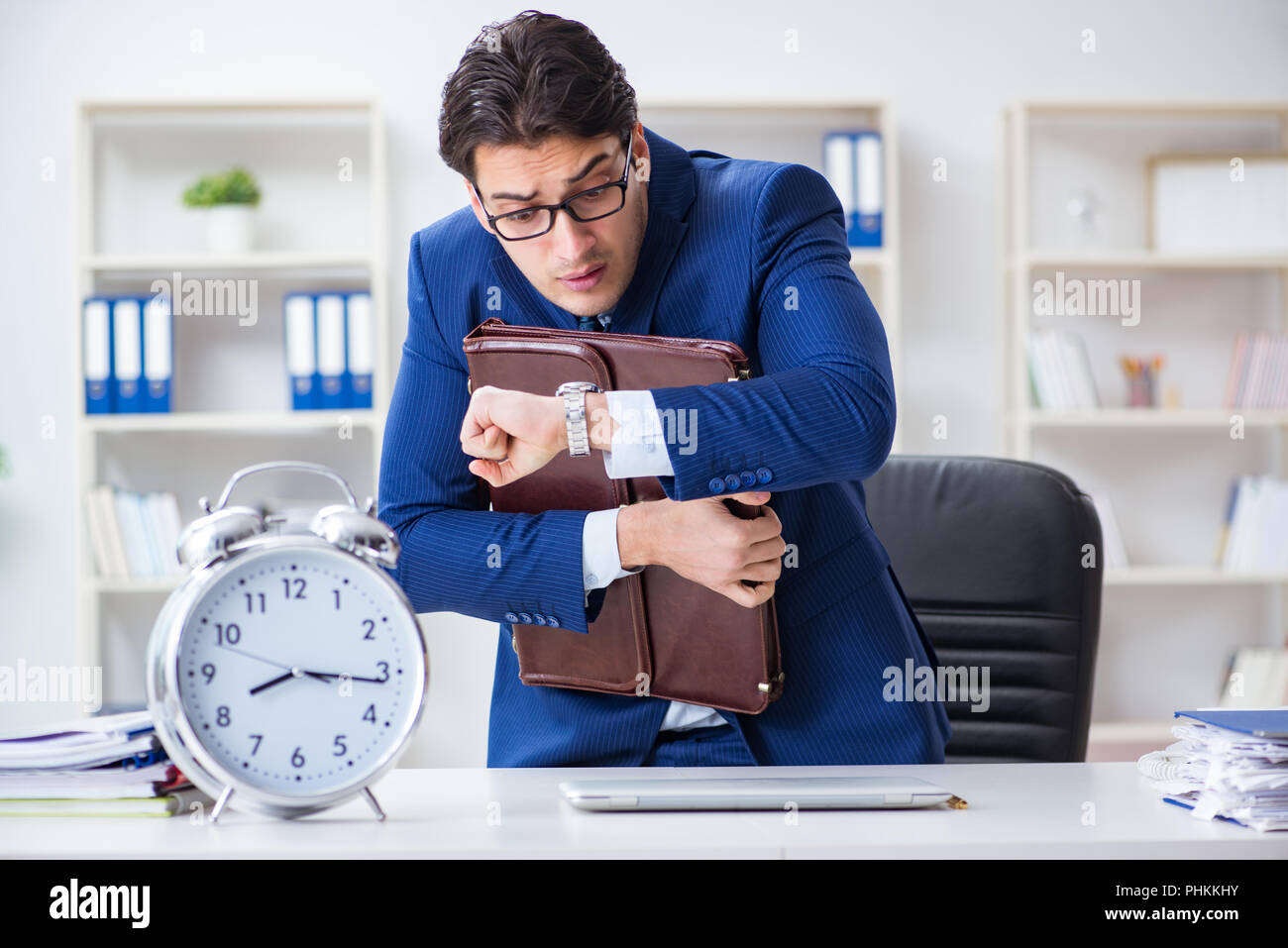 Businessman in bad time management concept Stock Photo - Alamy