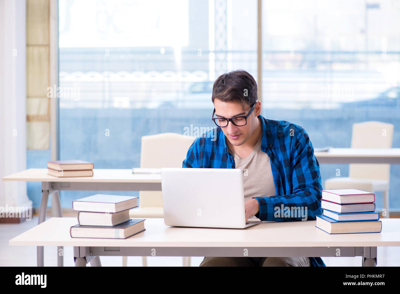 Student in telelearning distance learning concept reading in lib Stock Photo