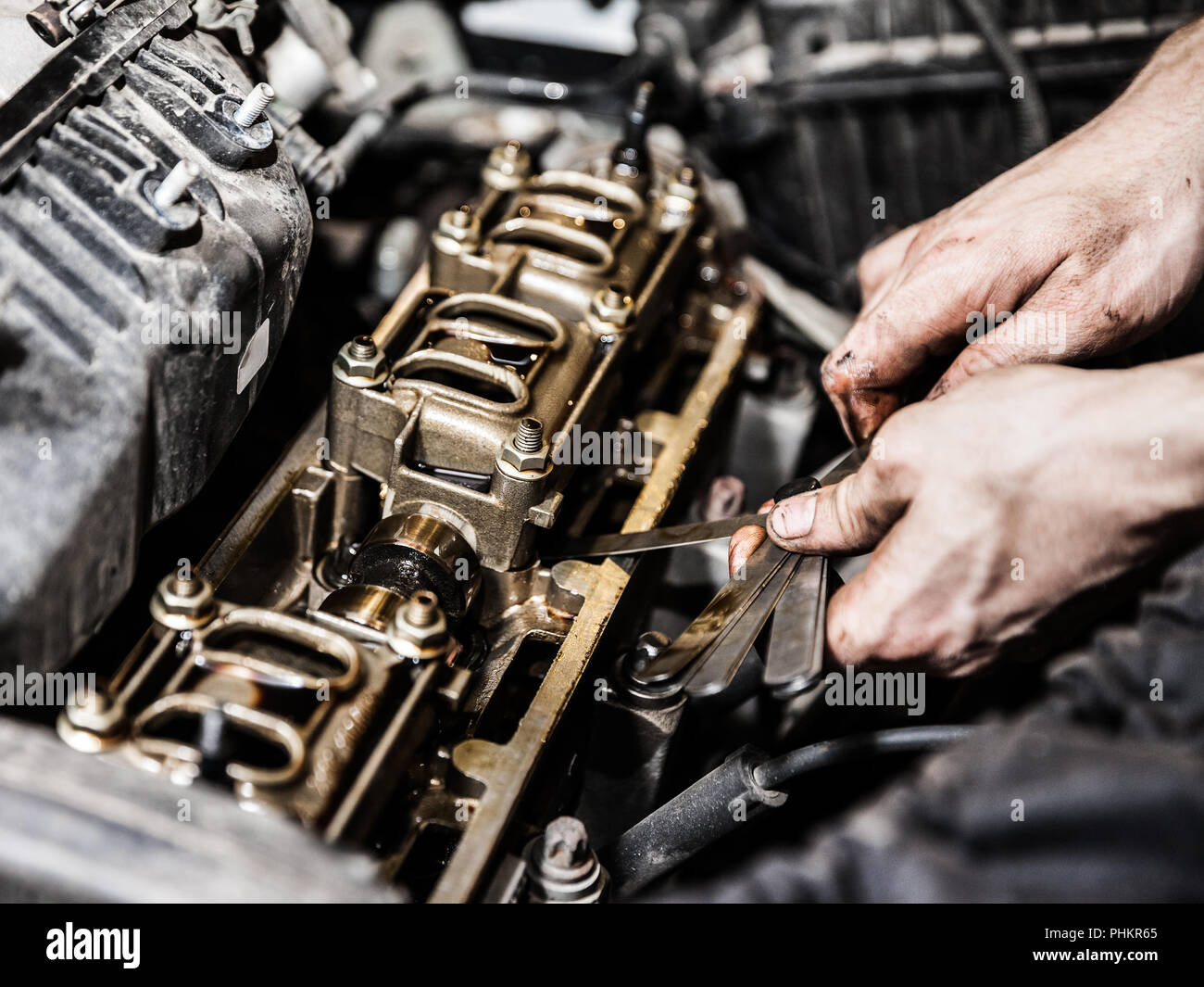 Automobile service worker or garage mechanic repairing auto car engine Stock Photo