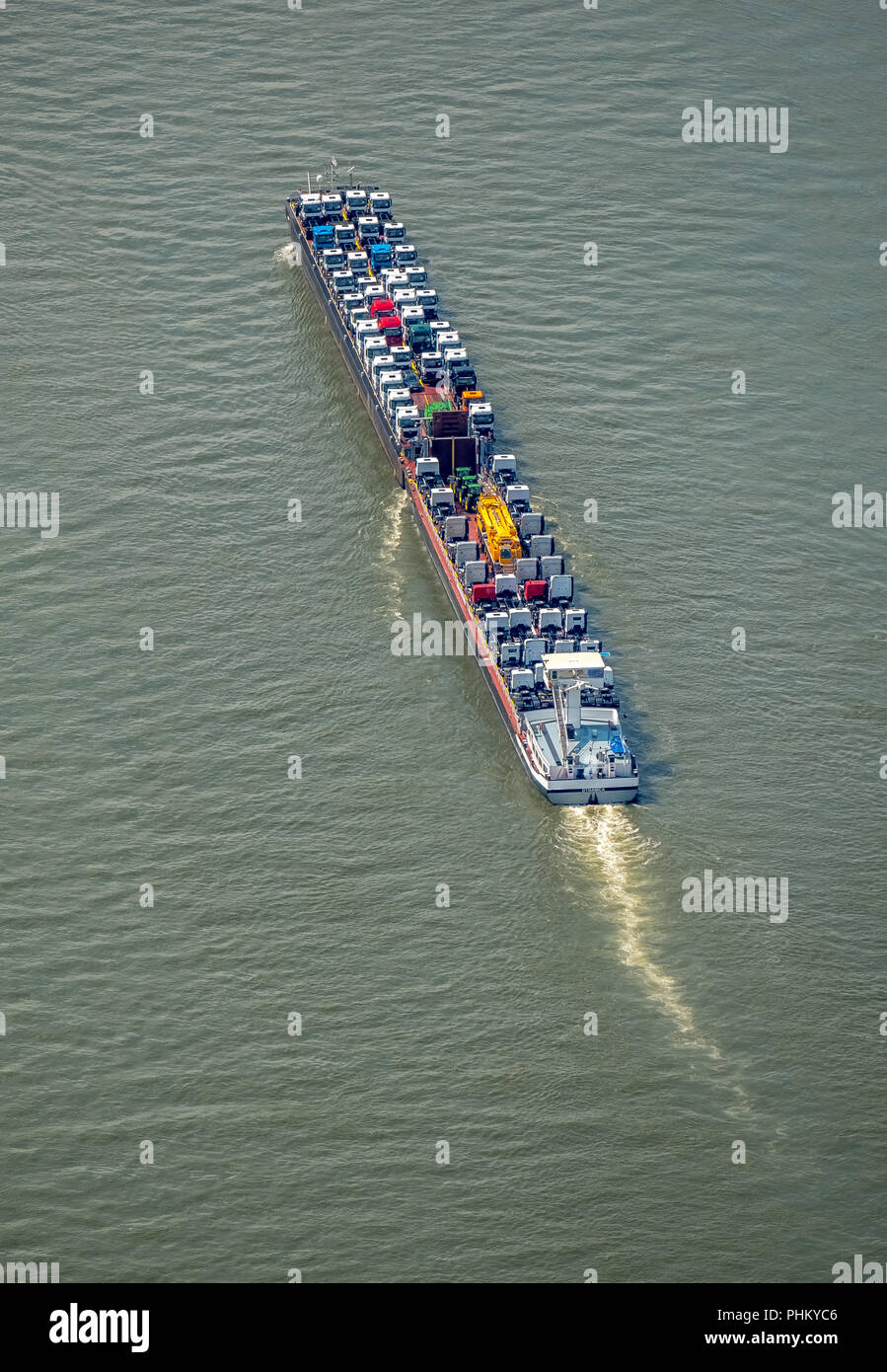 Aerial view, cargo ship on the Rhine goes uphill, push boat with additional lighters, tractors and trucks are the freight, inland navigation Duisburg, Stock Photo