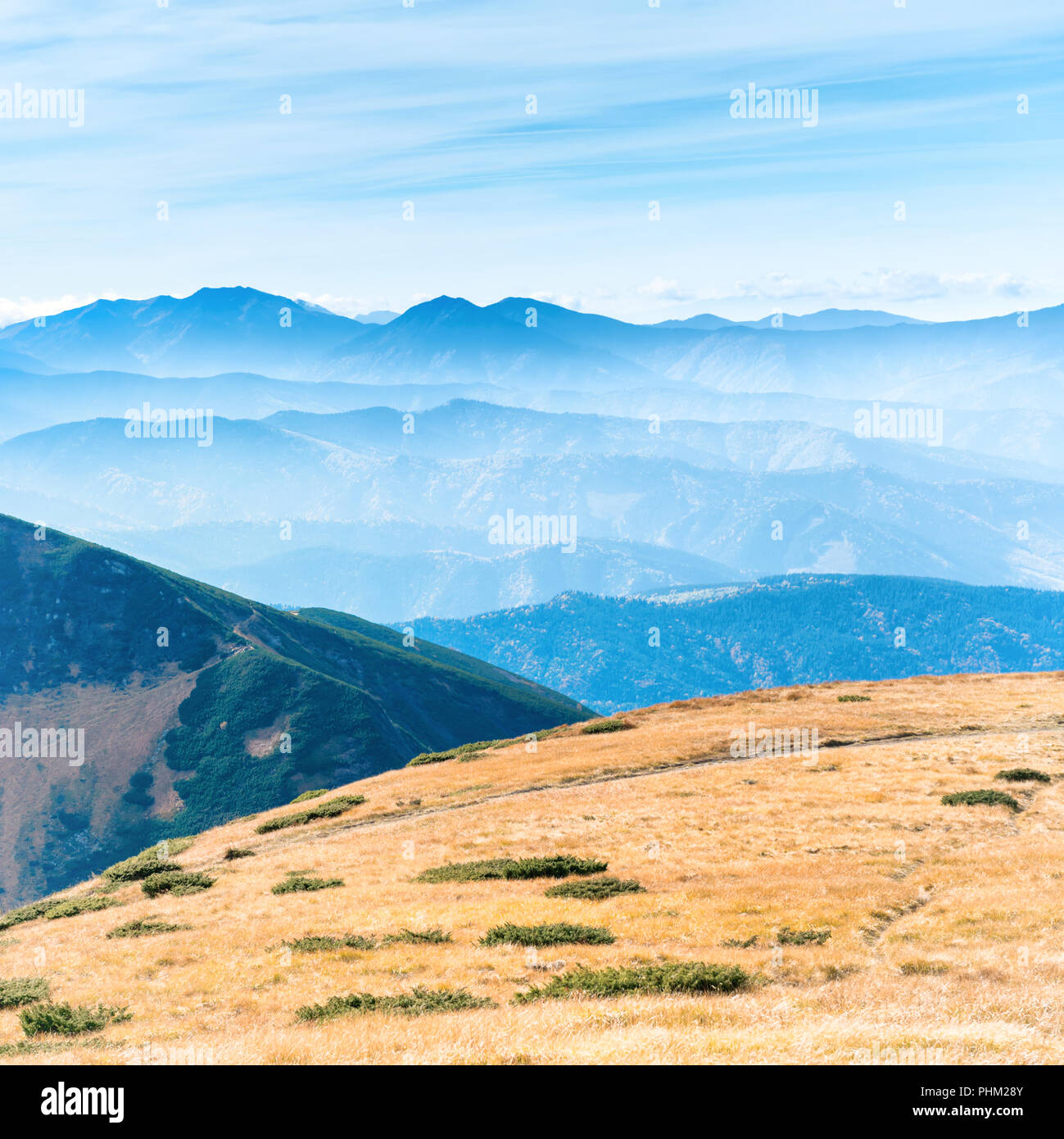 Mountains landscape with field of grass Stock Photo - Alamy