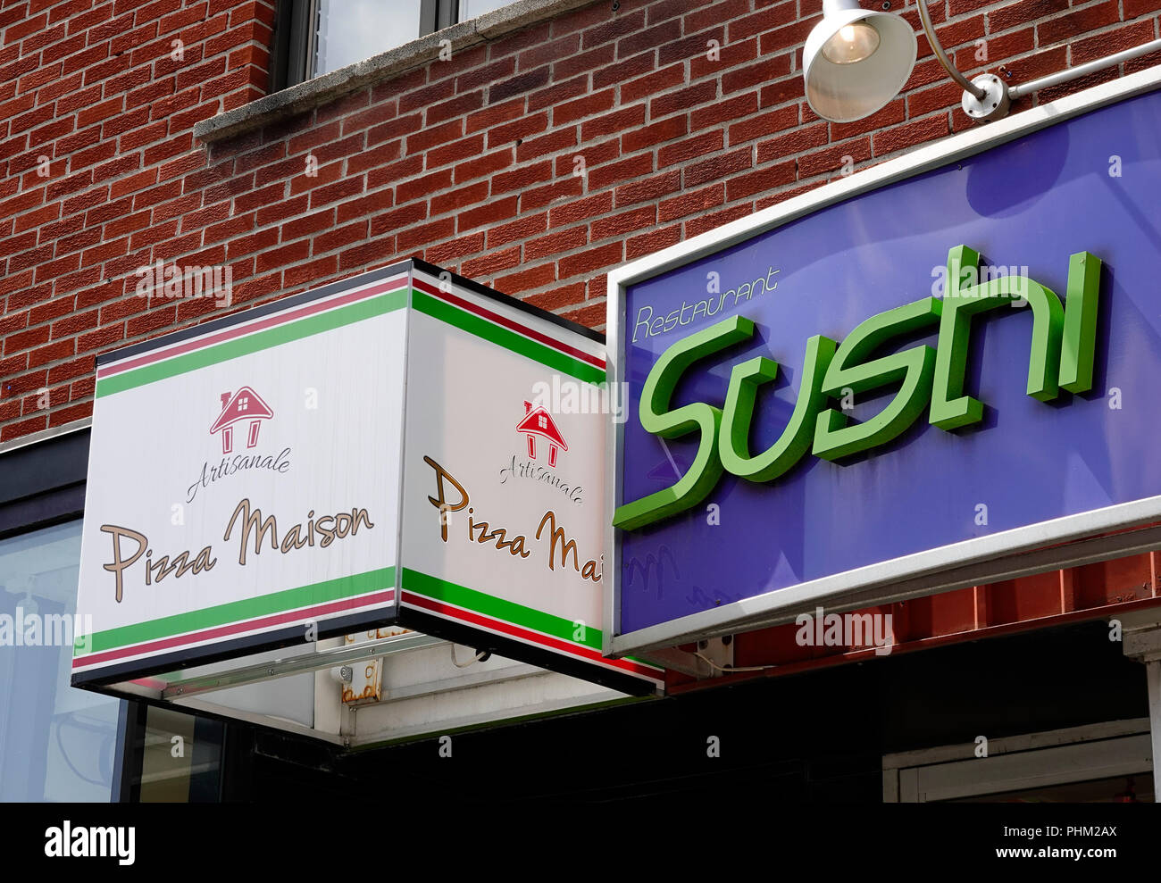 Sushi restaurant and pizzeria side by side in Montreal Stock Photo