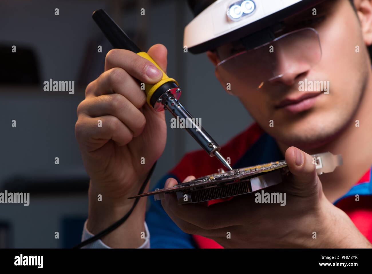 Computer specialist repairing PC late at night Stock Photo - Alamy
