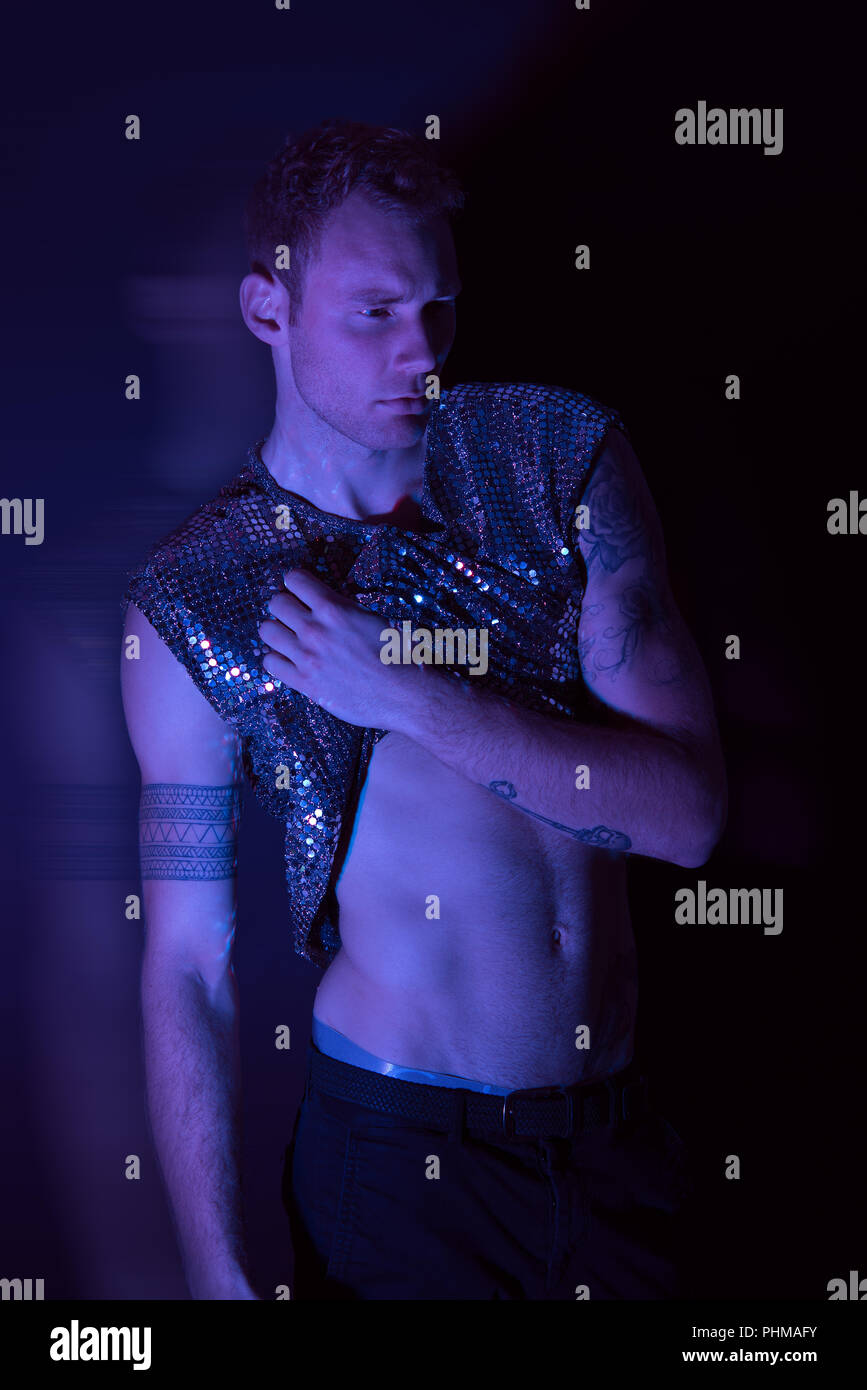 A high fashion futuristic male portrait shoot in a studio with blue light gel. Stock Photo
