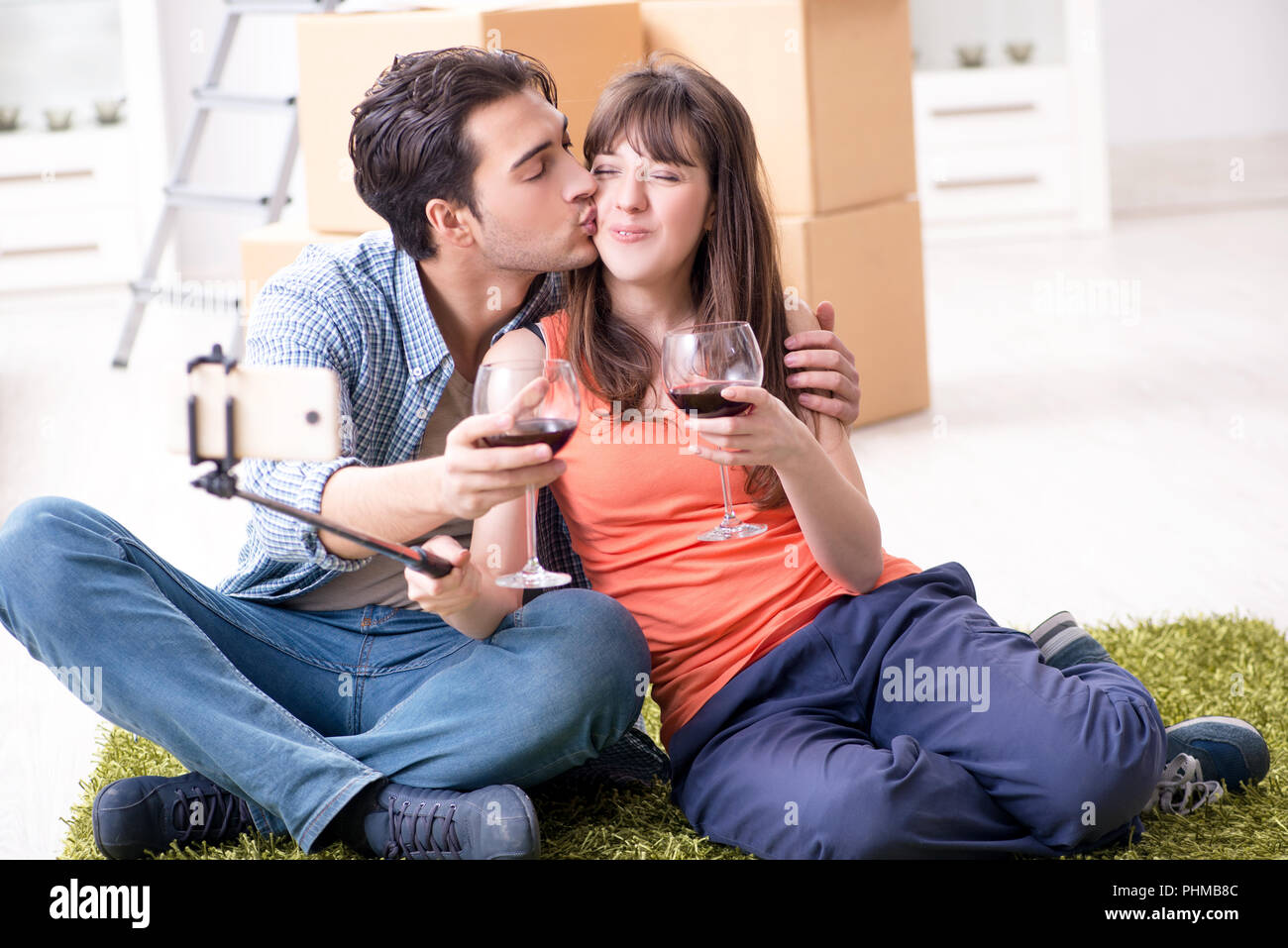 Couple taking selfie and drinking wine Stock Photo - Alamy