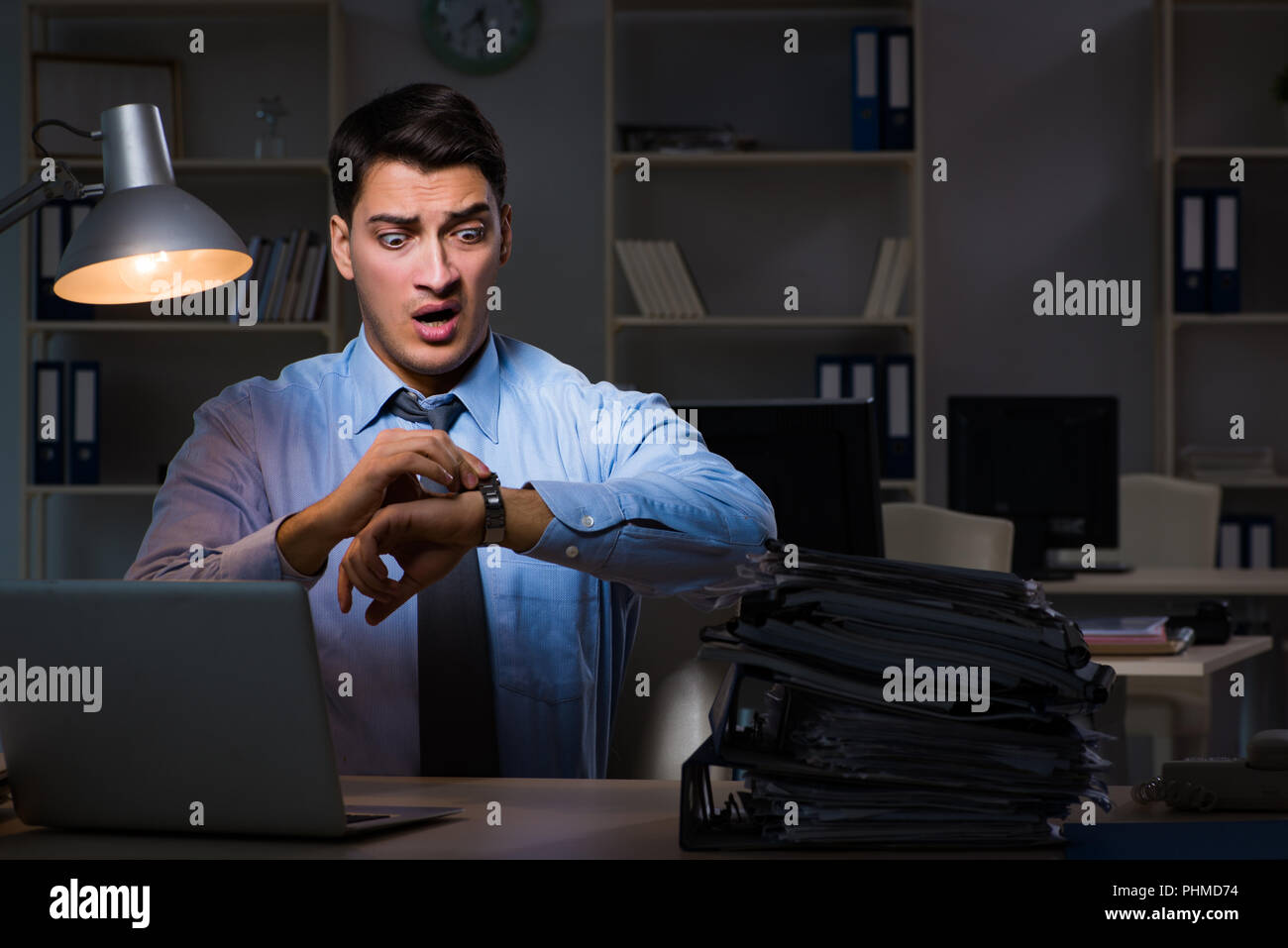 Employee working late at night at important report Stock Photo - Alamy