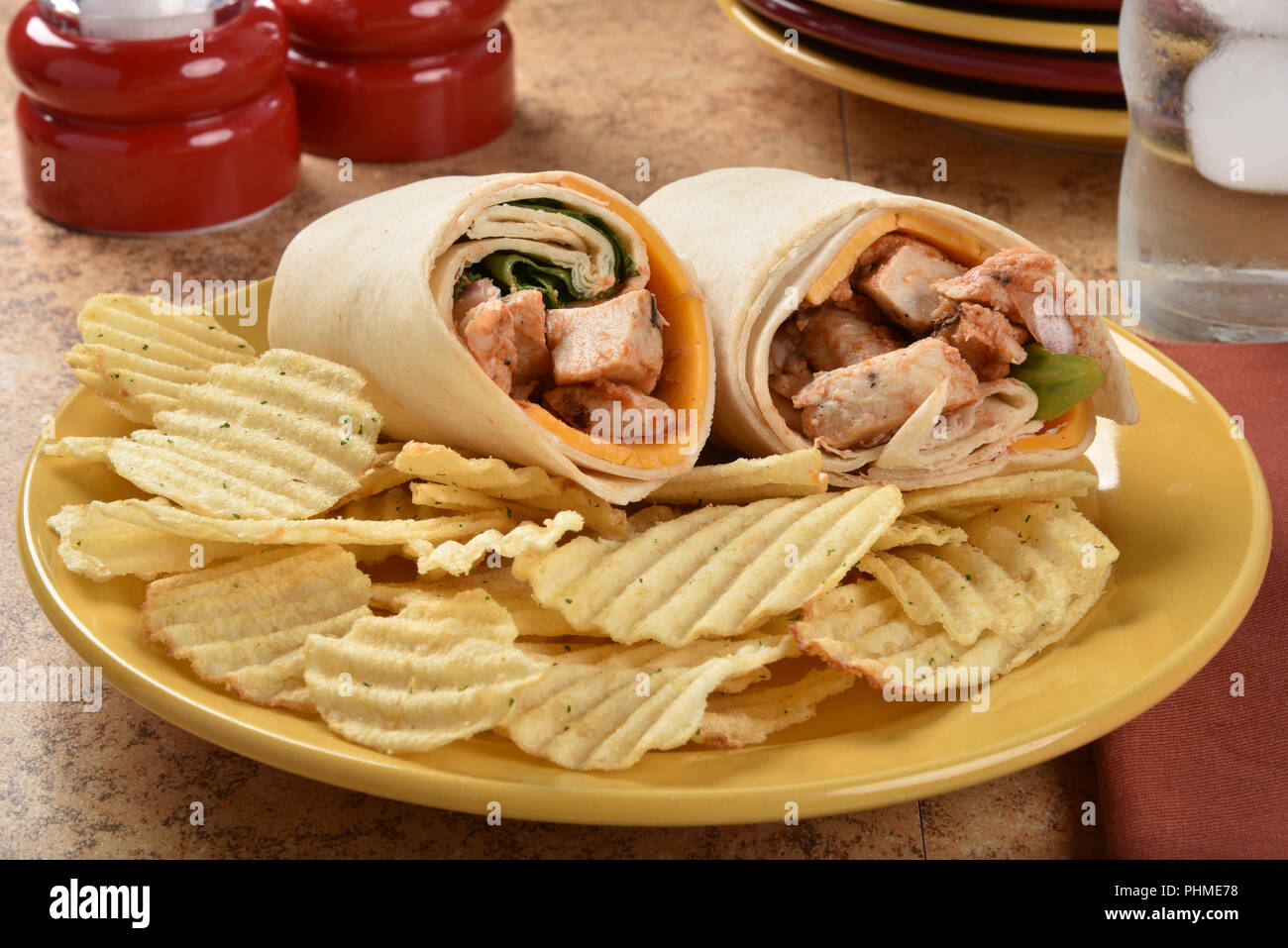 A chicken wrap sandwich with potato chips Stock Photo Alamy