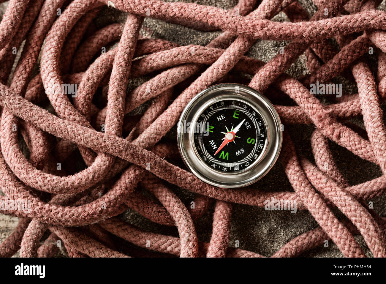 compass isolated on old ropes - closeup Stock Photo