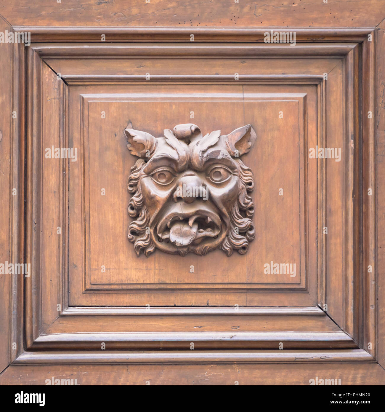 Italy - Mask on an old door Stock Photo