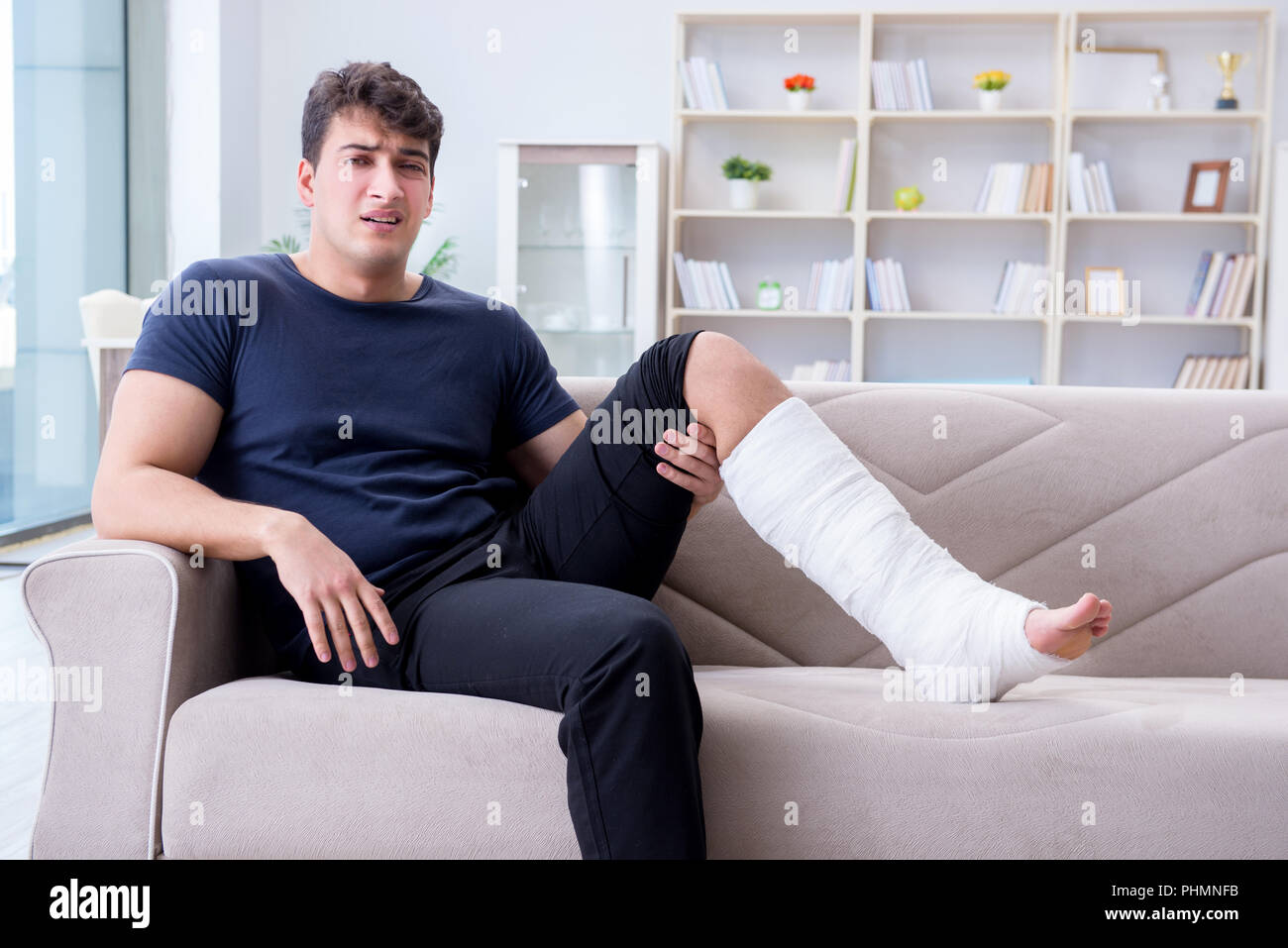 Man with broken leg recovering at home Stock Photo Alamy