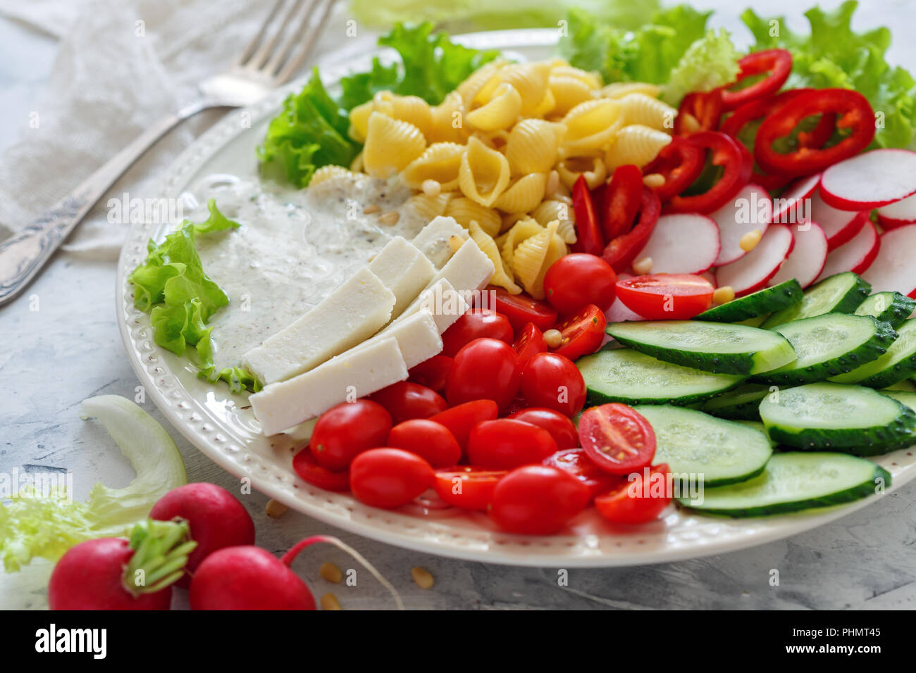 Vegetable salad with pasta and fresh cheese. Stock Photo