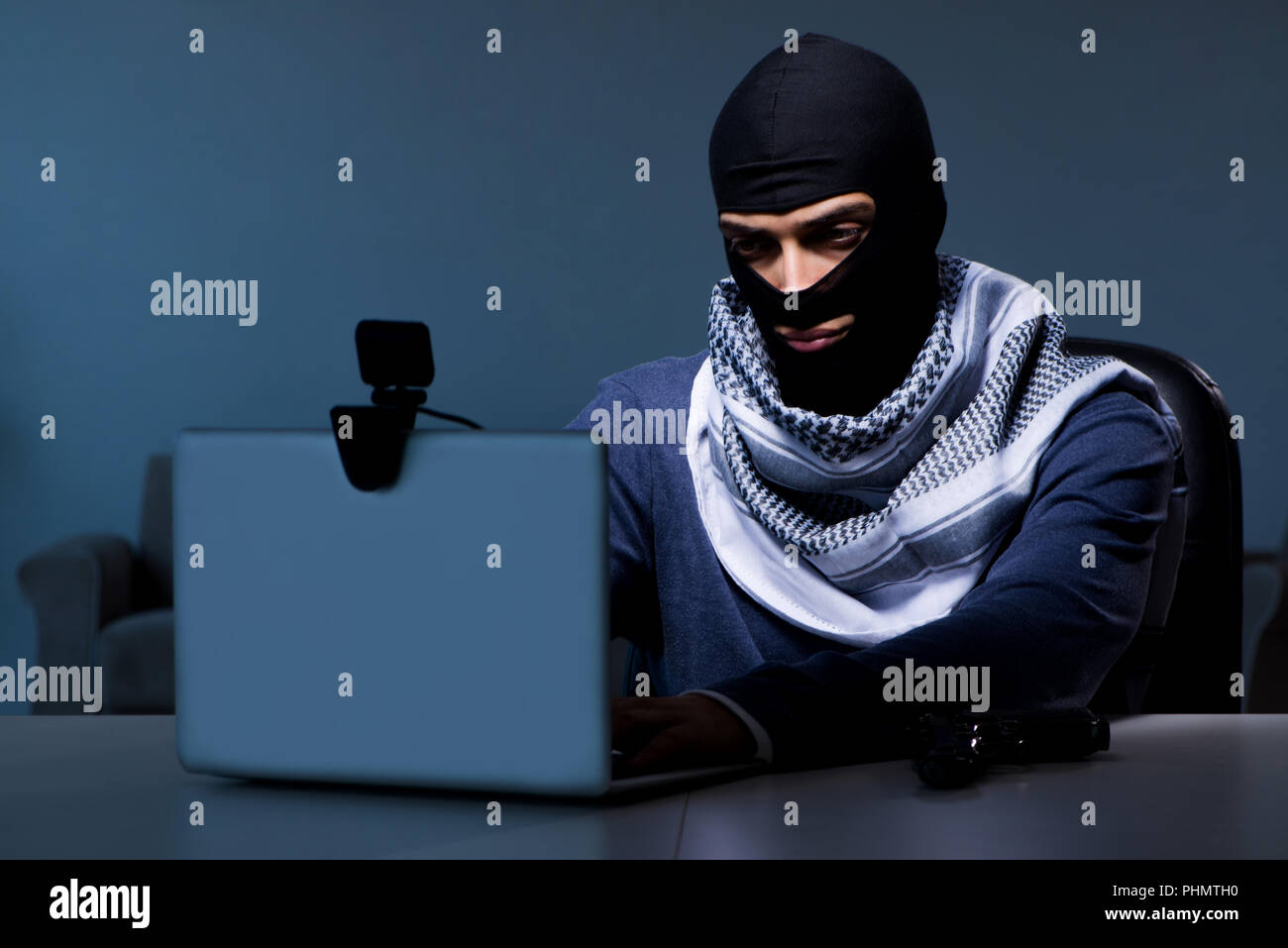 Hacker wearing balaclava mask hacking computer Stock Photo Alamy