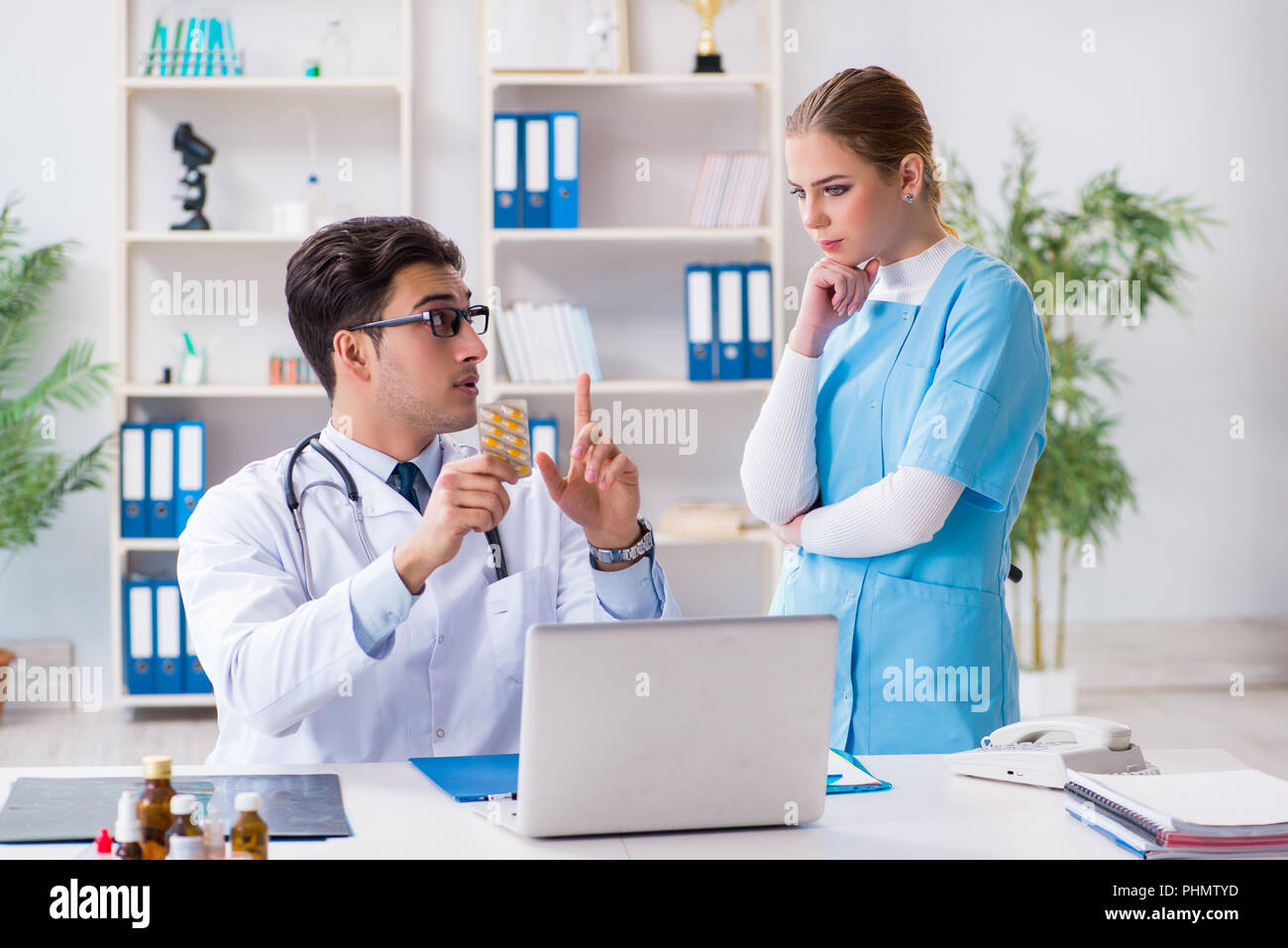 Male and female doctor having discussion in hospital Stock Photo - Alamy