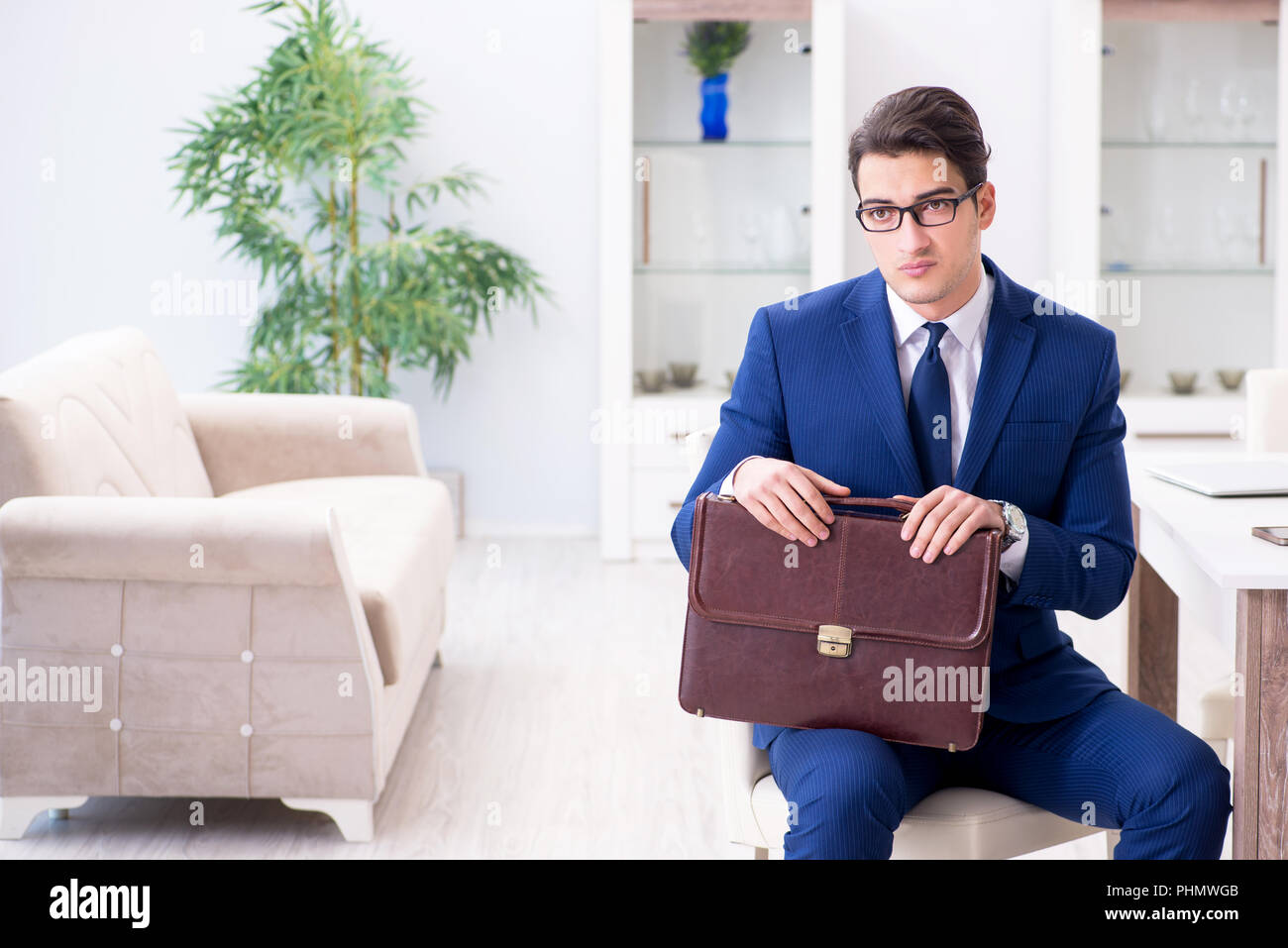 Bankrupt businessman angry and upset at home Stock Photo