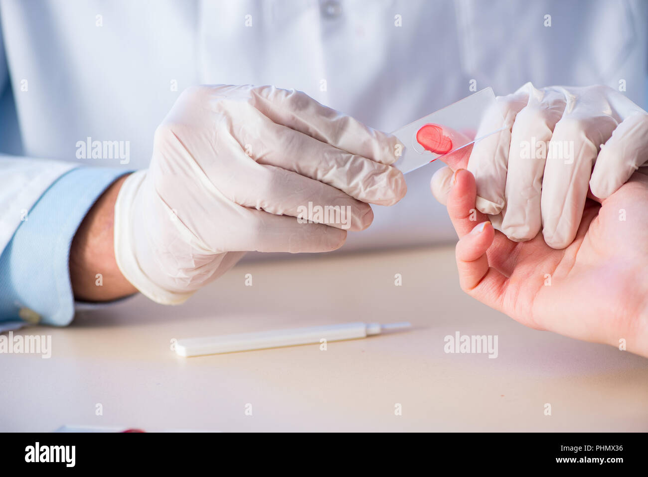 Doctor taking blood samples from finger Stock Photo Alamy