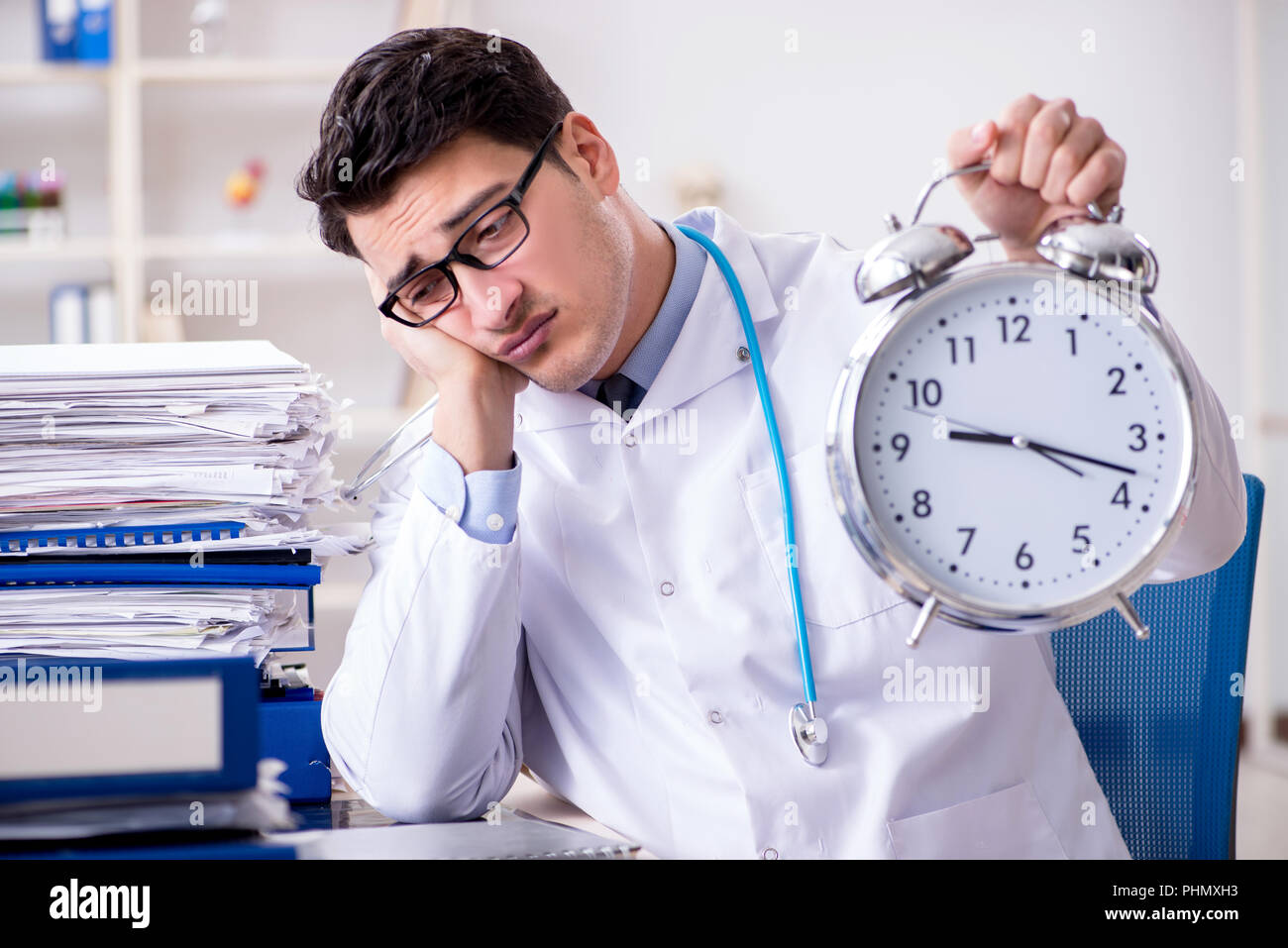 Doctor with alarm clock in urgent check-up concept Stock Photo - Alamy