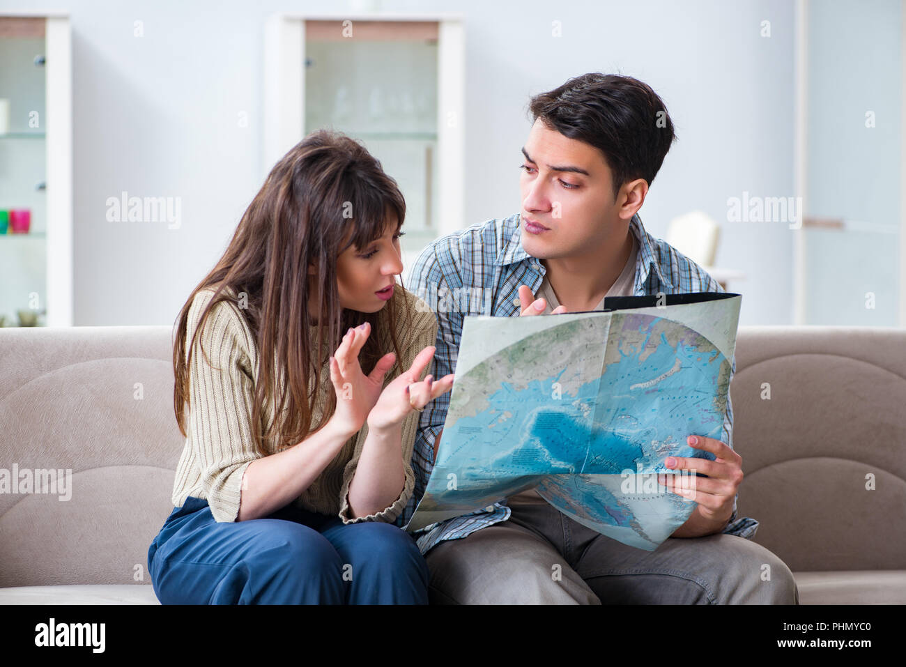 Young family discussing travel plans with map Stock Photo