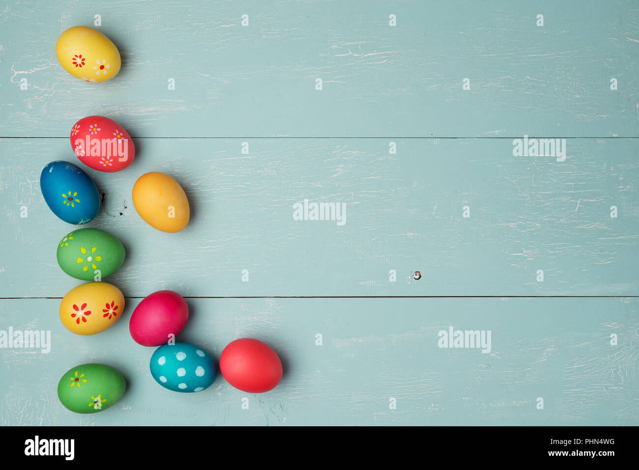 multicolored easter eggs on vintage  wooden background Stock Photo