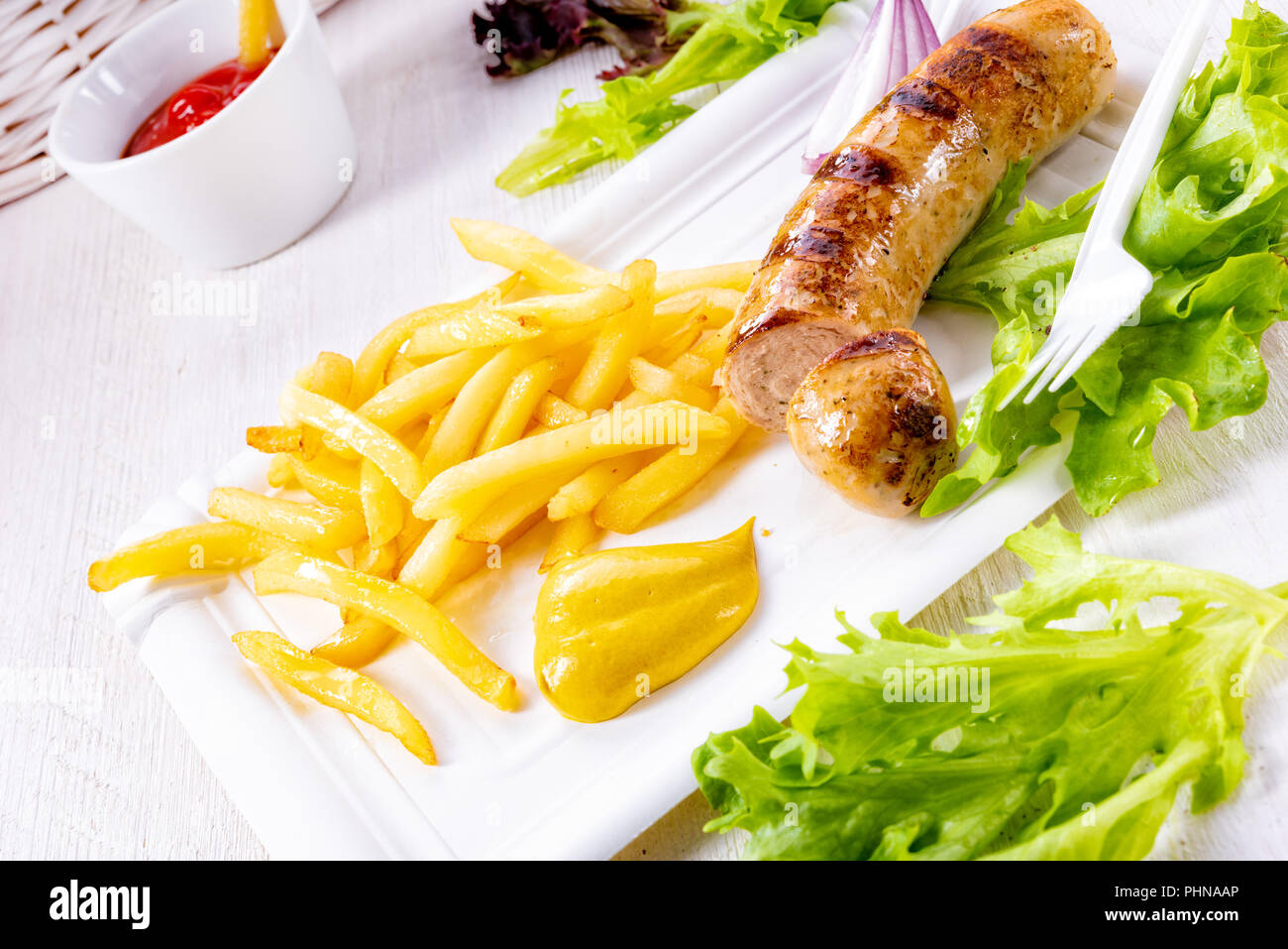 delicious grilled bratwurst with fries and mustard Stock Photo Alamy