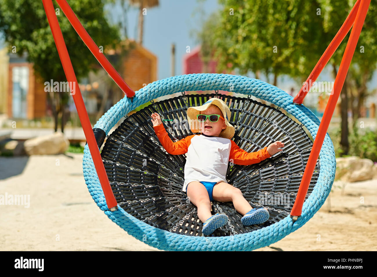 Toddler child swinging on beach Stock Photo Alamy