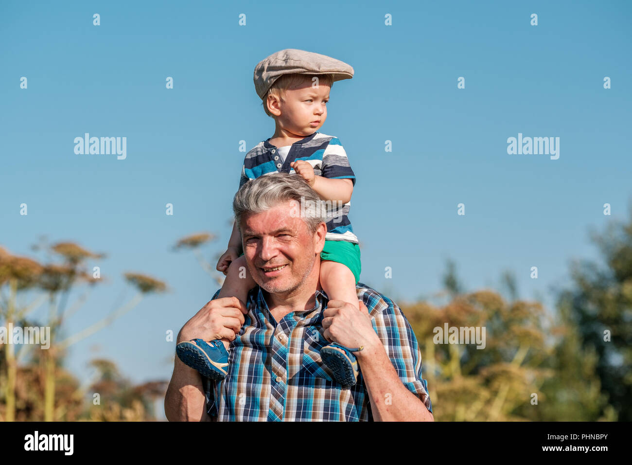 Boy Pretending To Fly While Grandfather Holds Him Over Shoulder High-Res  Stock Photo - Getty Images