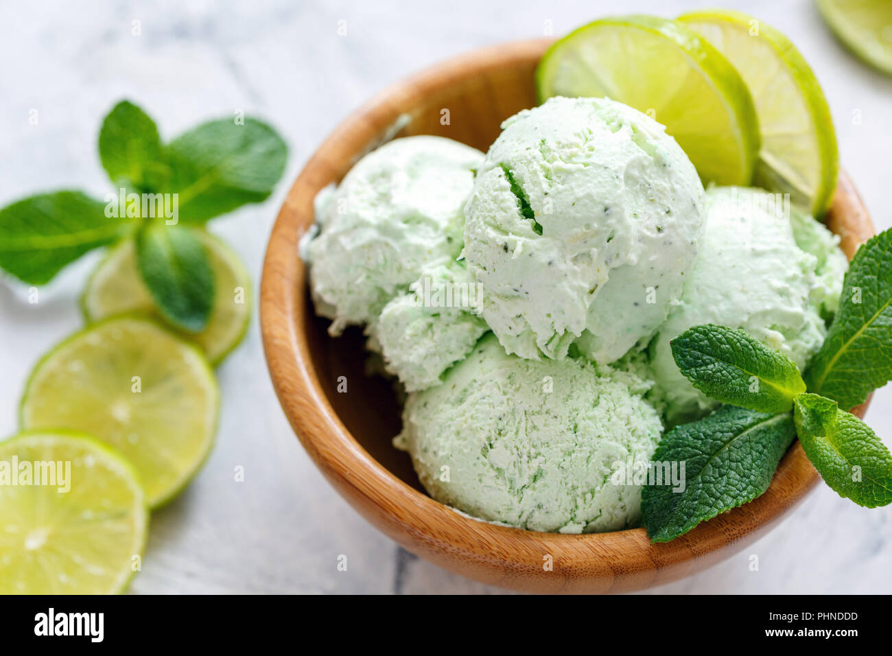 Mojito ice cream with lime slices and mint sprigs. Stock Photo