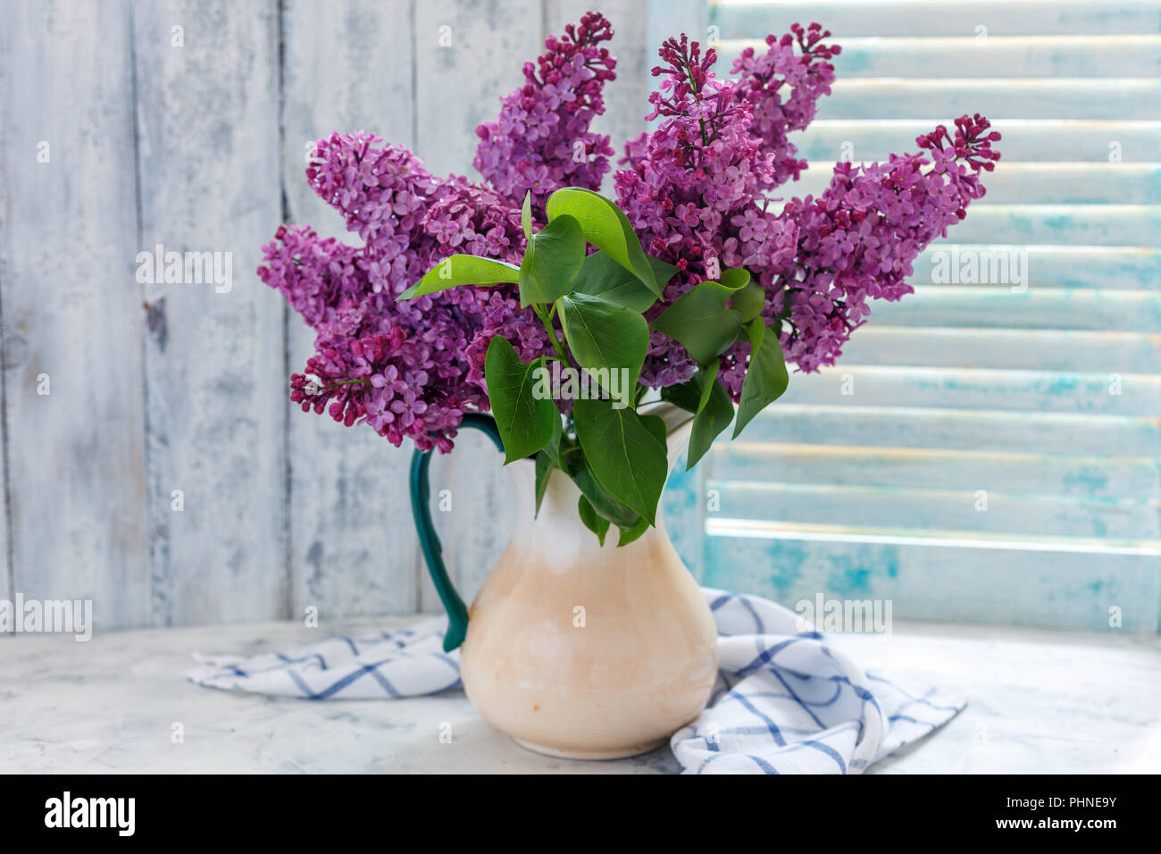 Blooming lilacs in a ceramic jug. Stock Photo