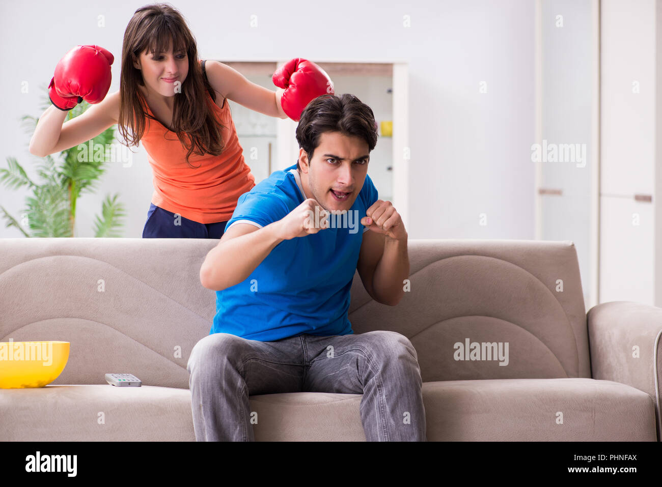 Wife unhappy that husband is watching boxing Stock Photo Alamy