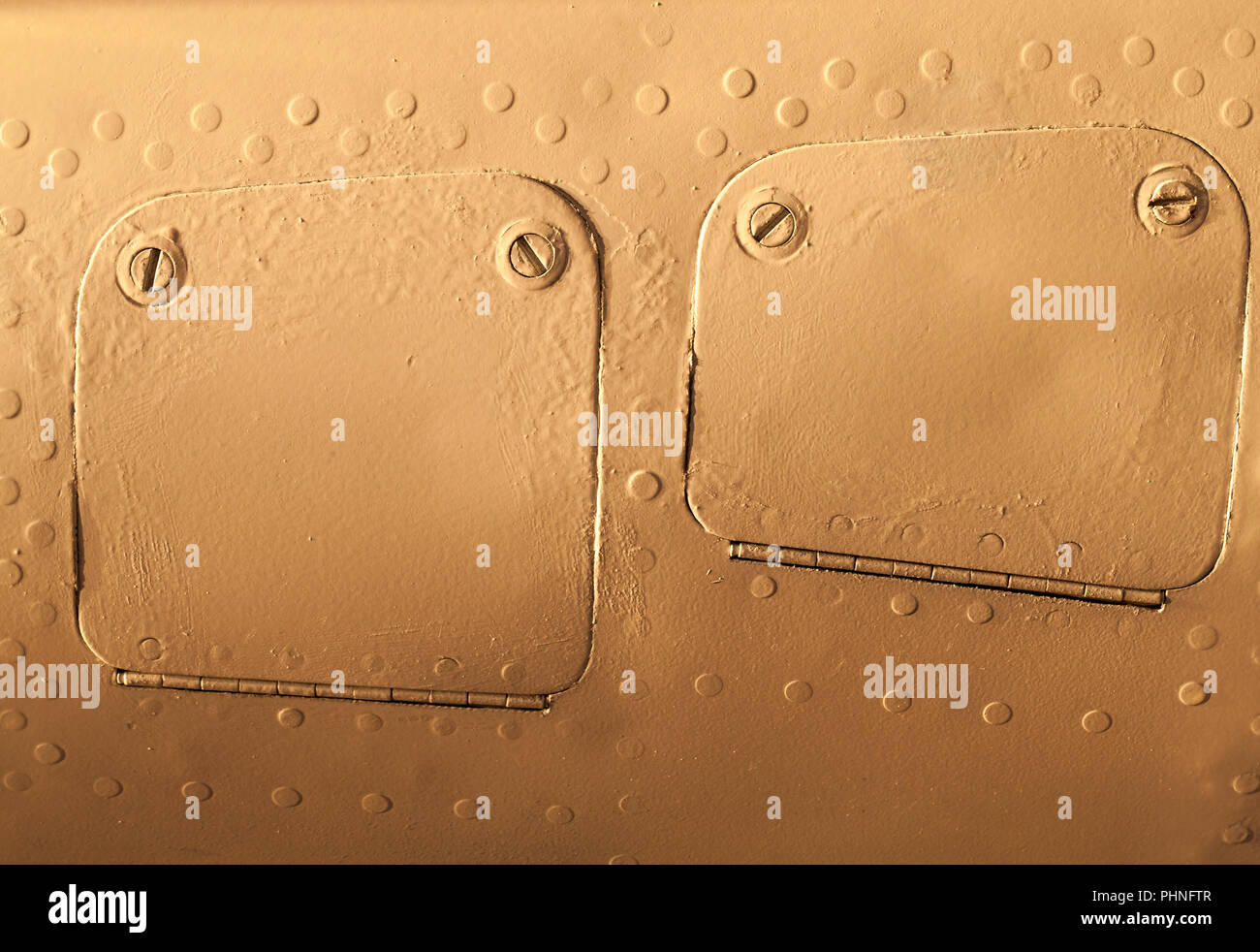 an old orange metal construction joined by aluminum rivets, used in