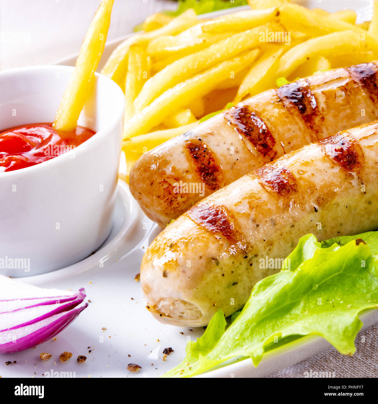 grilled bratwurst with chips and cold beer Stock Photo Alamy