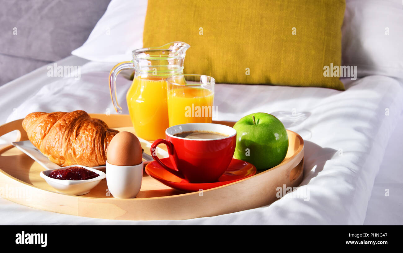 Breakfast on tray in bed in hotel room Stock Photo - Alamy