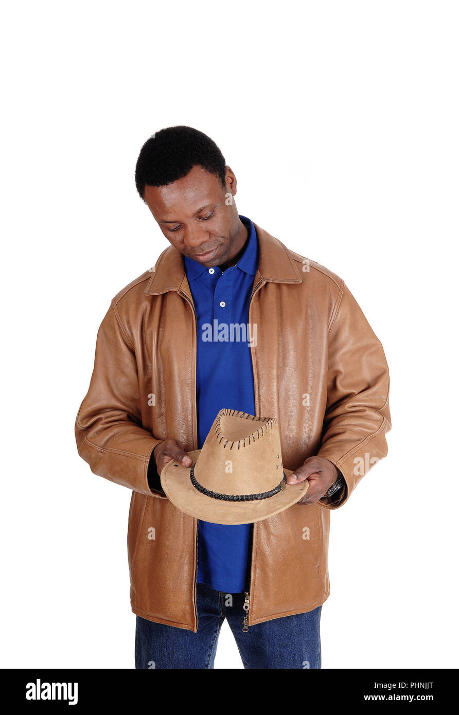 Handsome man in brown leather jacket holding his hat Stock Photo