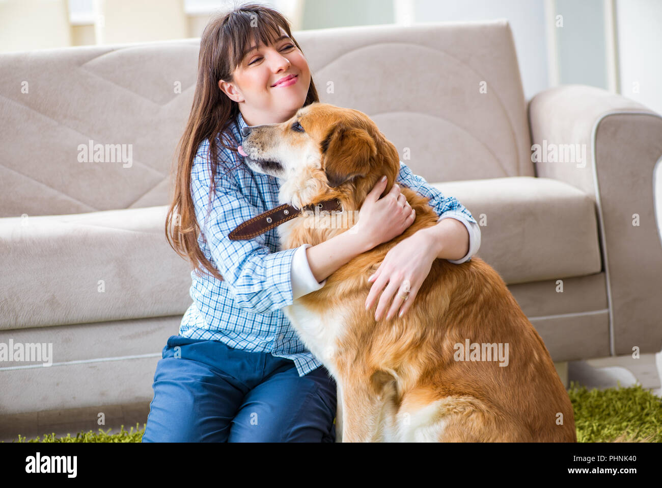 Happy woman dog owner at home with golden retriever Stock Photo Alamy
