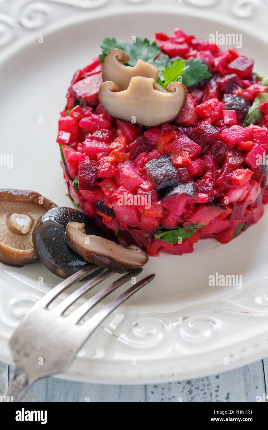 Traditional Russian salad with marinated mushrooms. Stock Photo