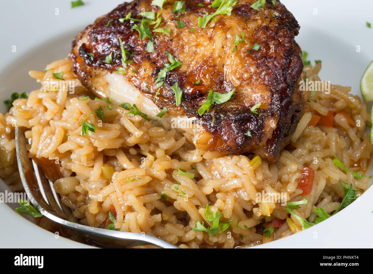 An English pub main course dish of Chili lime Chicken with braised rice. Stock Photo