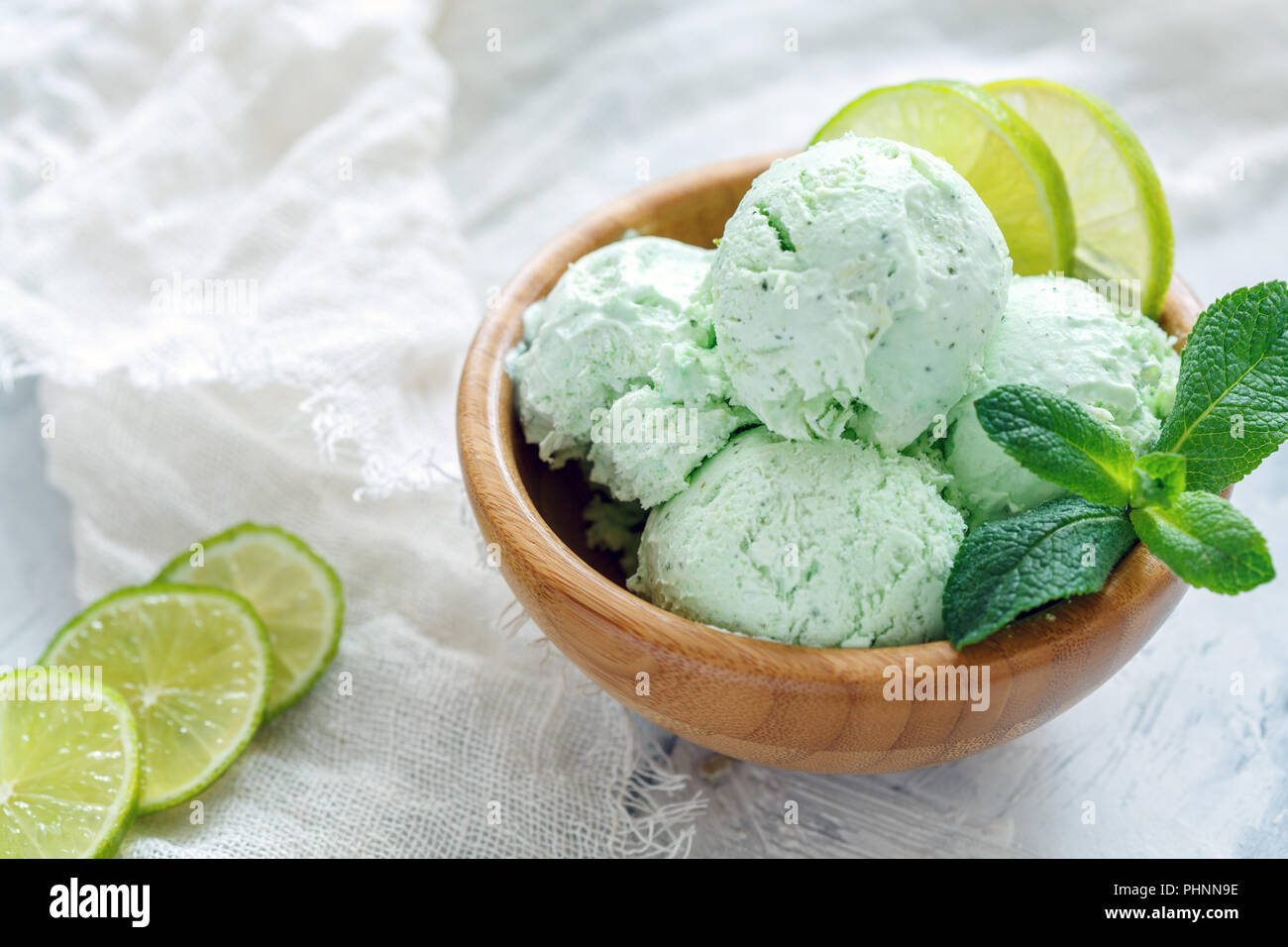 Mojito ice cream with lime slices and mint sprigs. Stock Photo