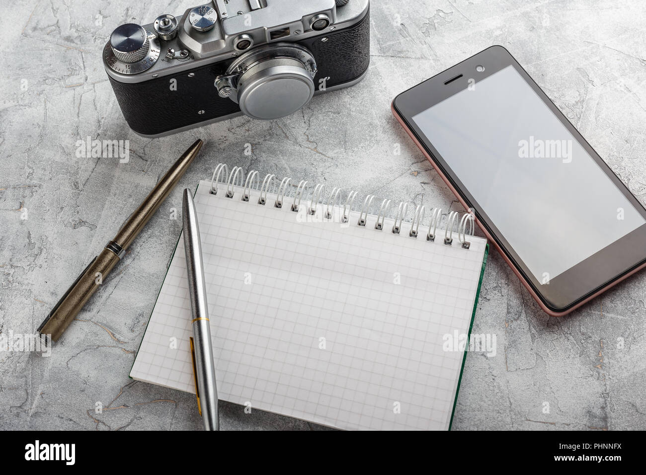 Notebook with film camera. Stock Photo