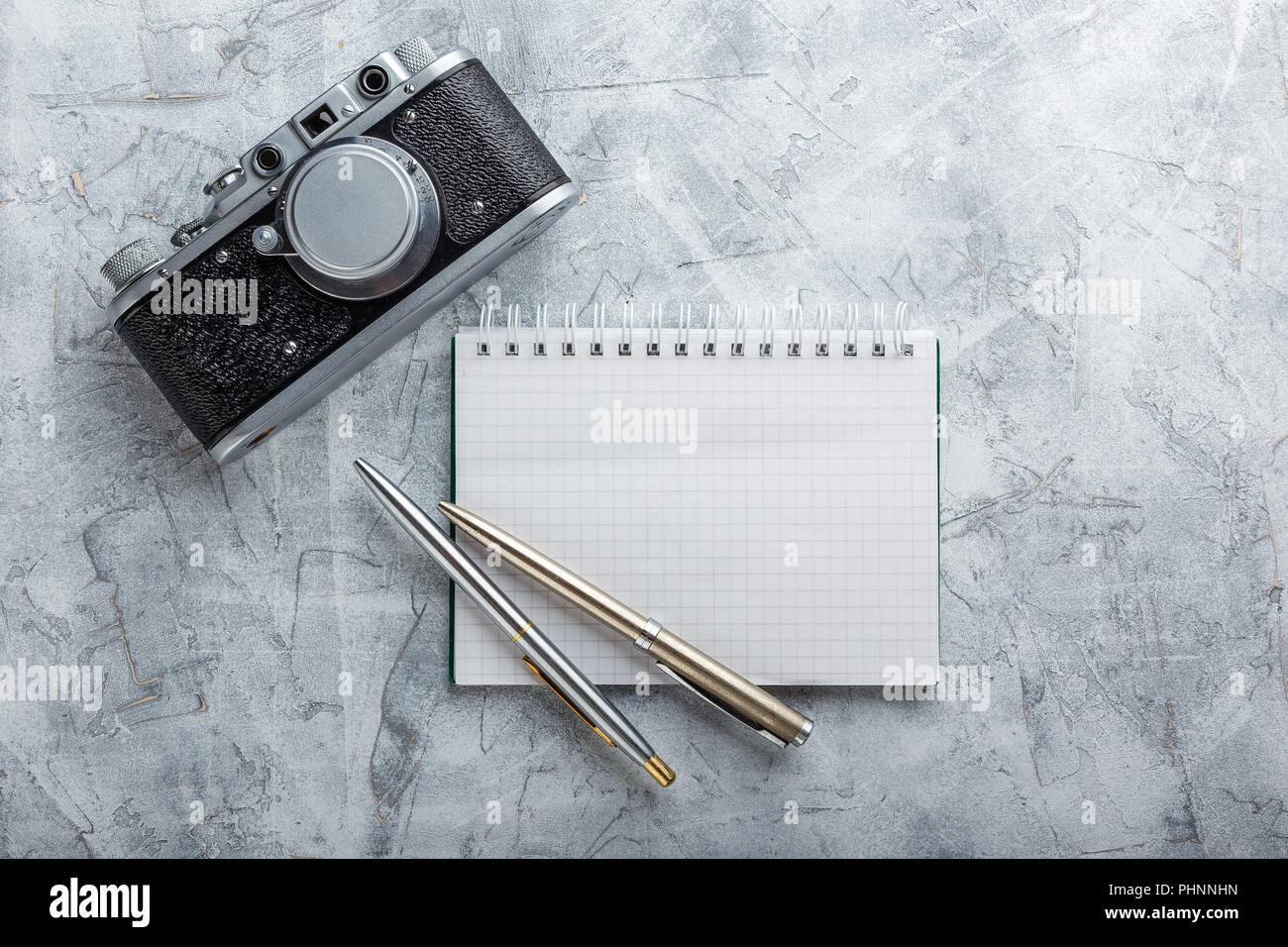 Notebook with film camera. Stock Photo