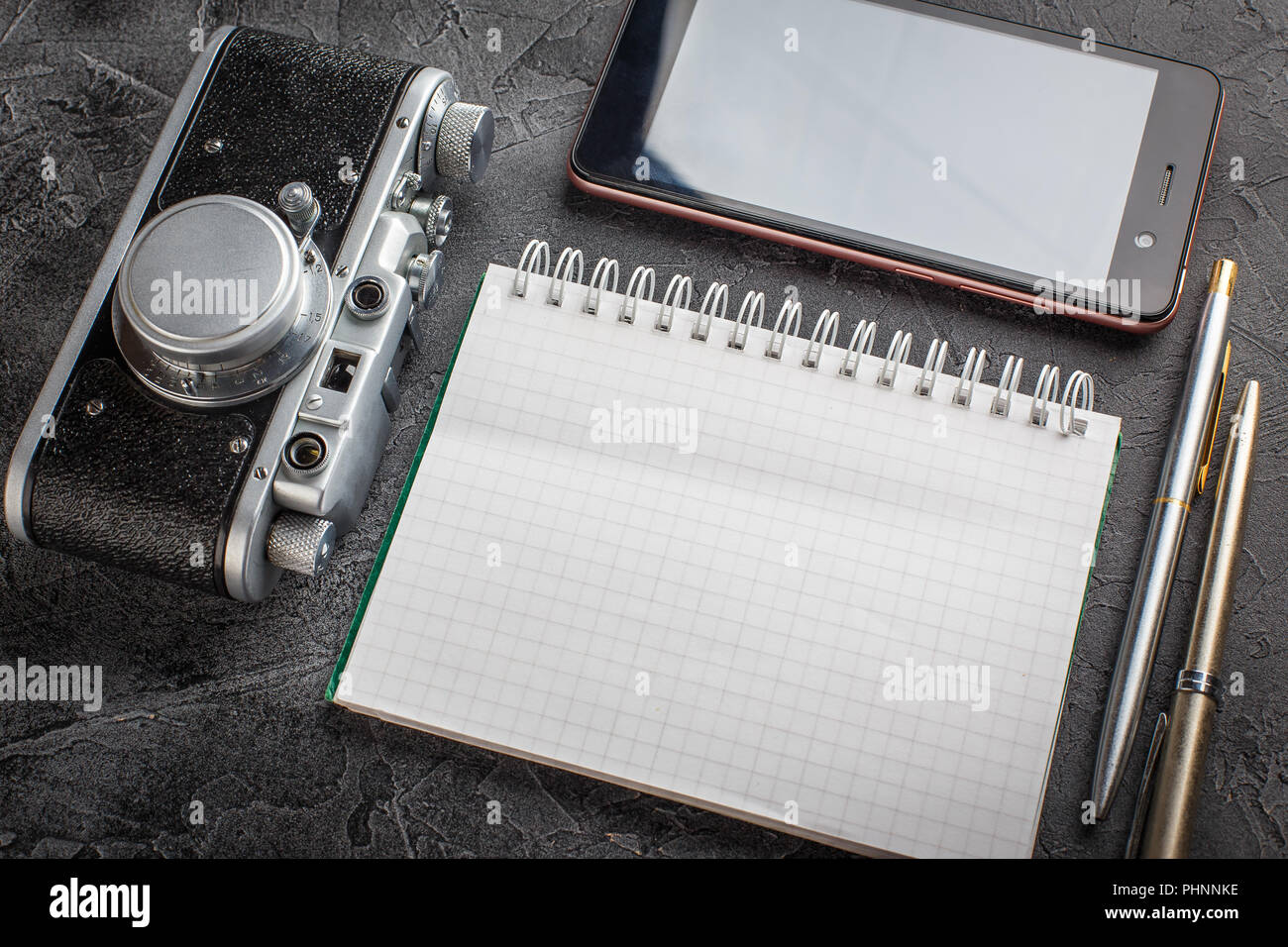 Notebook with film camera. Stock Photo